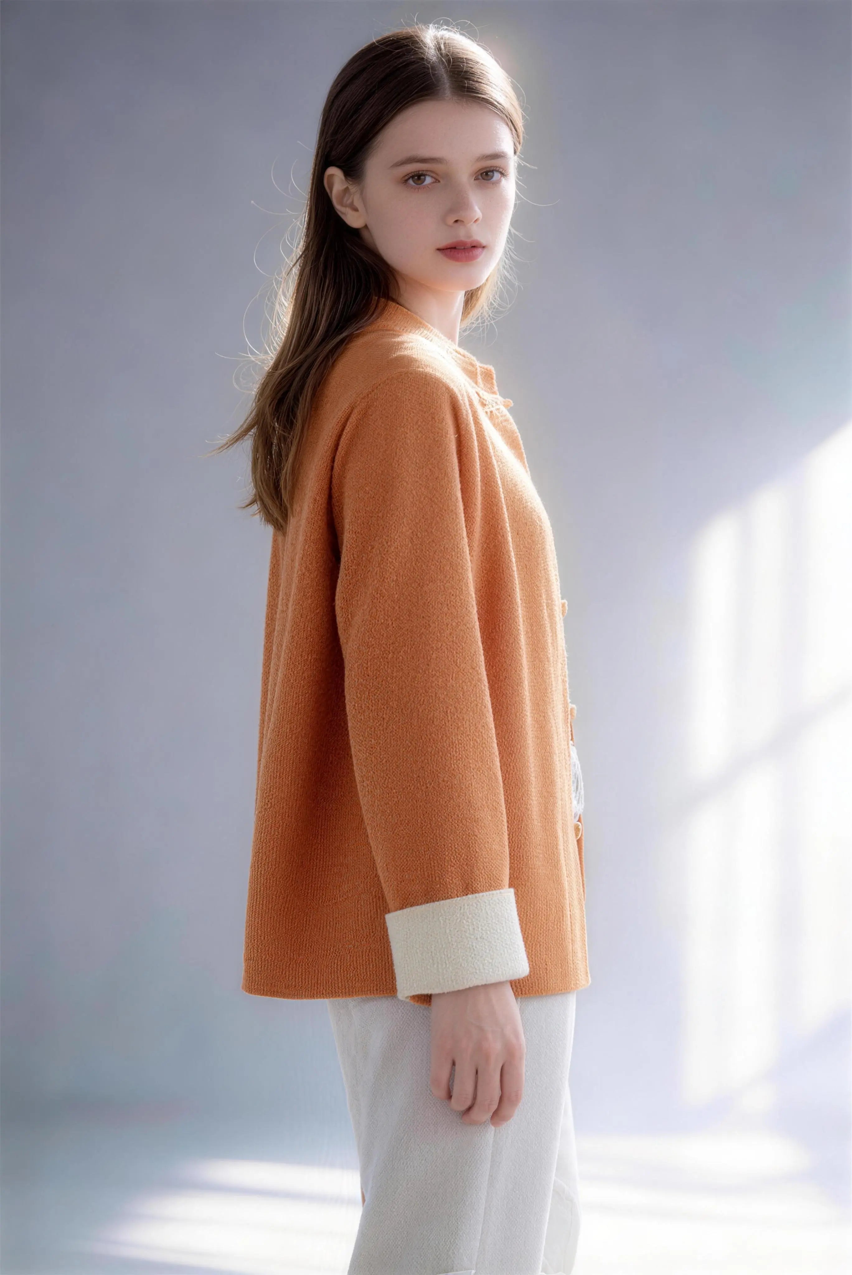 Model wearing new chinese style orange knit cardigan contrast frog button stand collar loose coat