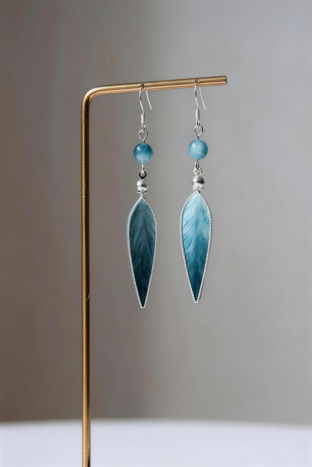 Model wearing blue jiangnan intangible cultural heritage ronghua bamboo leaf earrings