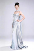 Model wearing Phoehua premium ice blue satin mermaid gown, minimalist studio shot highlighting luxurious fabric texture, graceful posture and sophisticated design.
