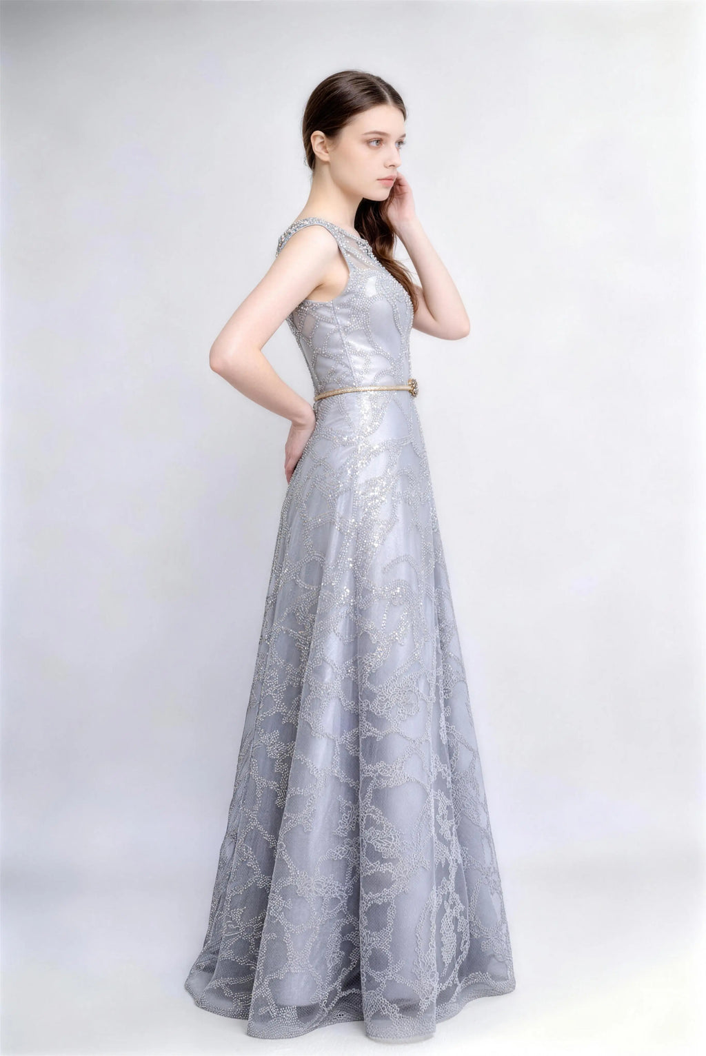 Model wearing silver beaded lace illusion neck evening gown