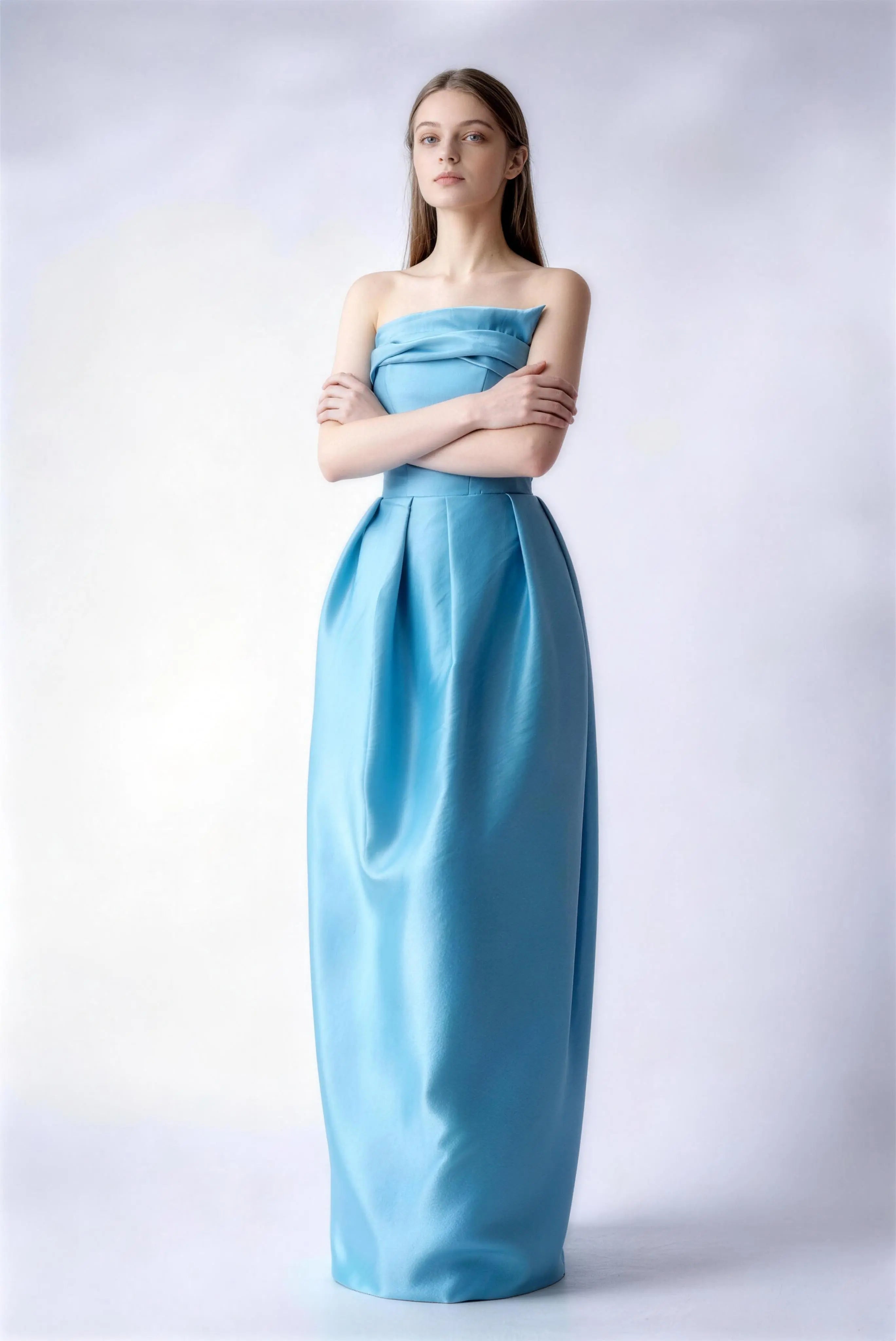 Model wearing lake blue strapless draped satin evening gown