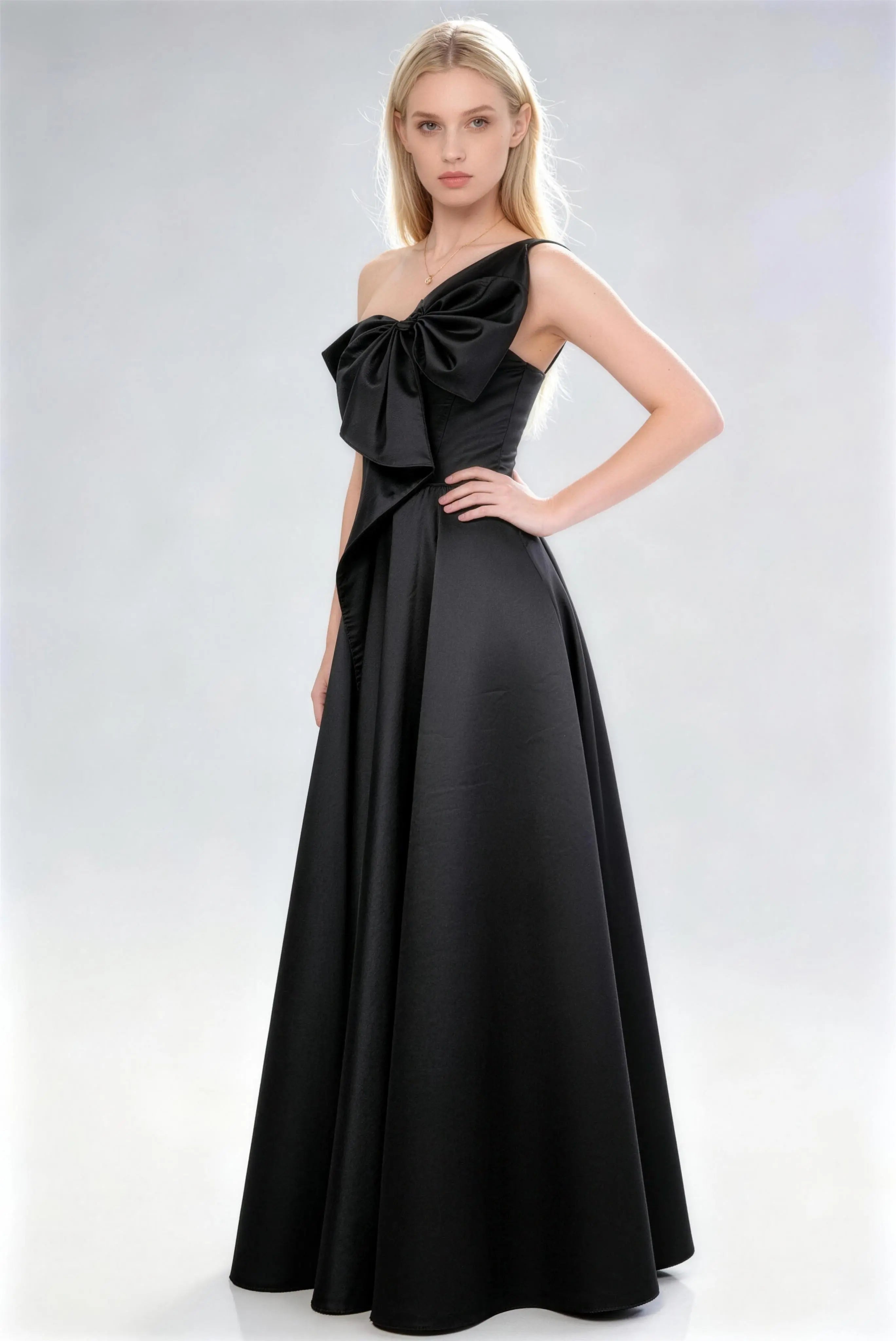Phoehua Side Pose of Black One‑Shoulder Oversized Bow Dress, Silky Acetate Satin A‑Line Floor‑Length Wedding Guest Formal Gown