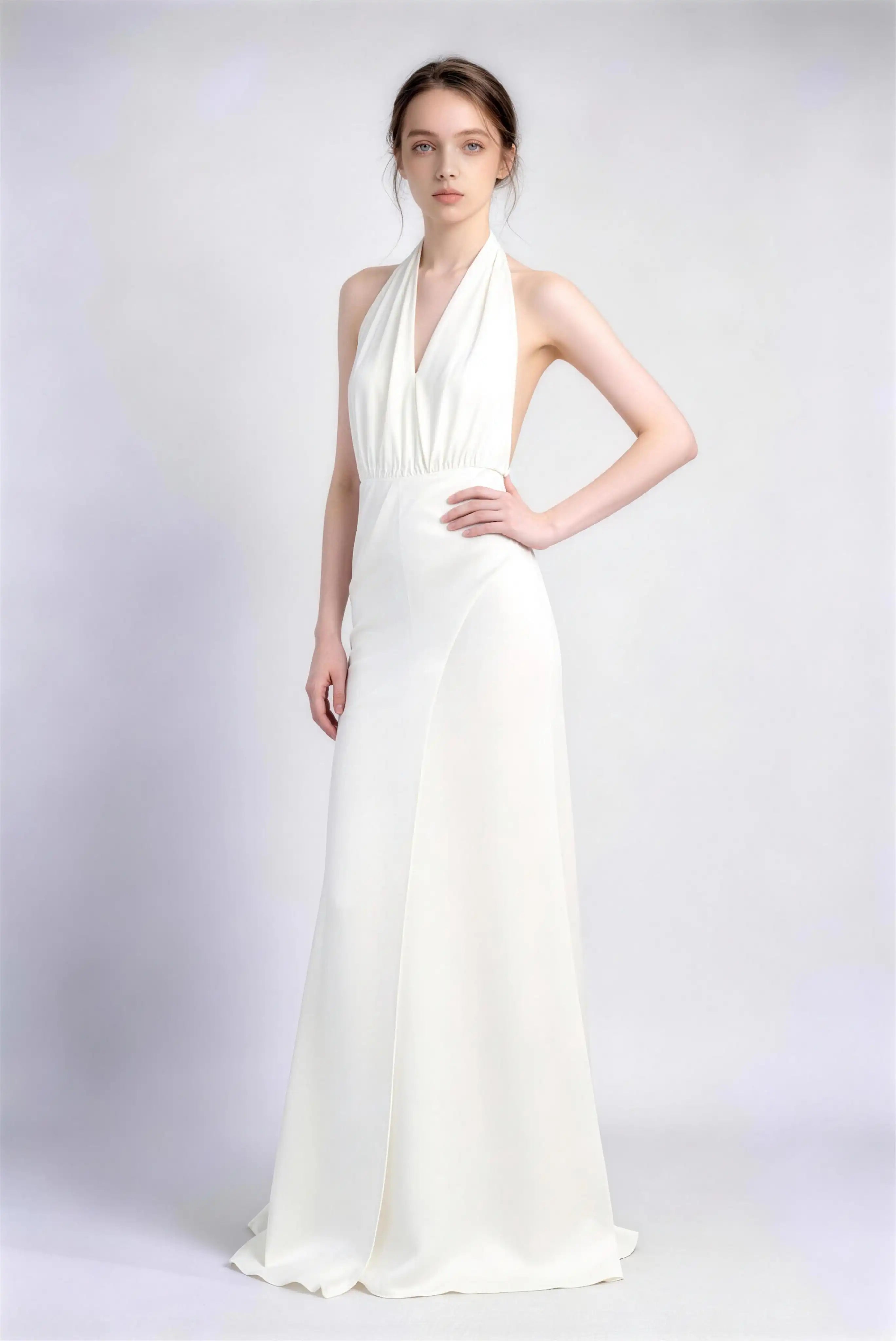 Model wearing white halter open‑back satin formal evening gown