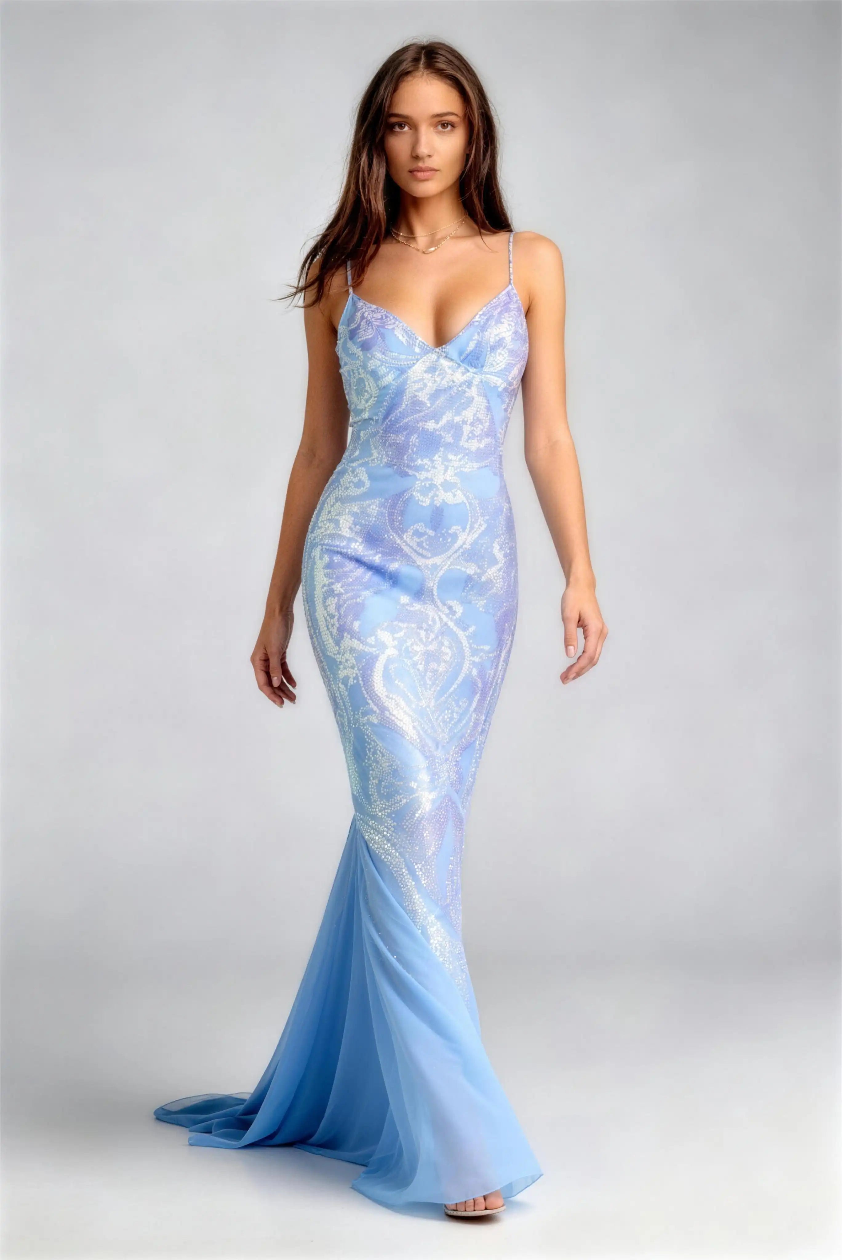 Model wearing blue sequined crisscross back mermaid formal evening gown