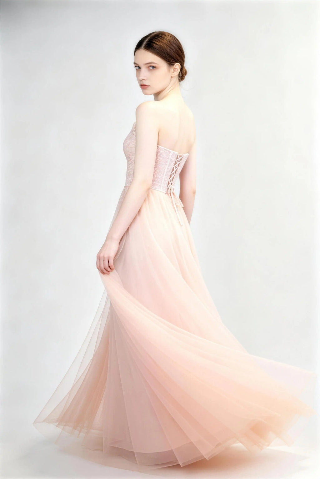 Phoehua Side Twirl‑Pose View of Light Pink Elegant Formal Evening Gown, Strapless Lace‑Corset Lace‑Up‑Back High‑Waist Tulle A‑Line Wedding Guest Long Dress