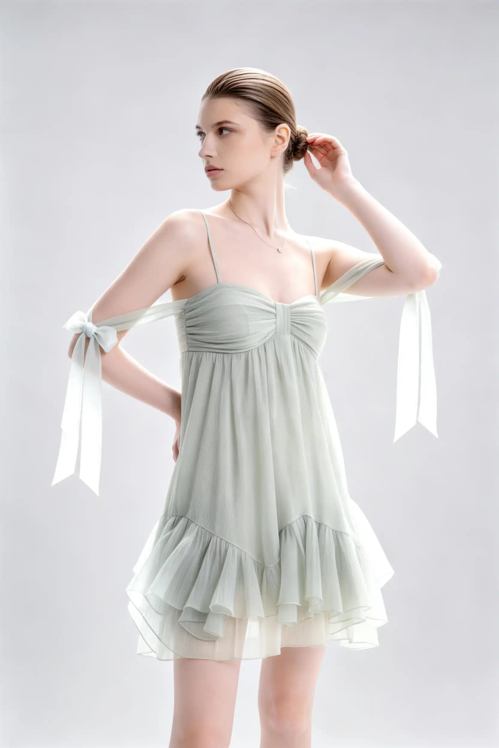 Phoehua Side Pose View of Sage Green Fresh Vacation Dress, Spaghetti‑Strap Bow‑Tie‑Strap Backless Elastic‑Waist Crinkled‑Chiffon A‑Line Mini Dress