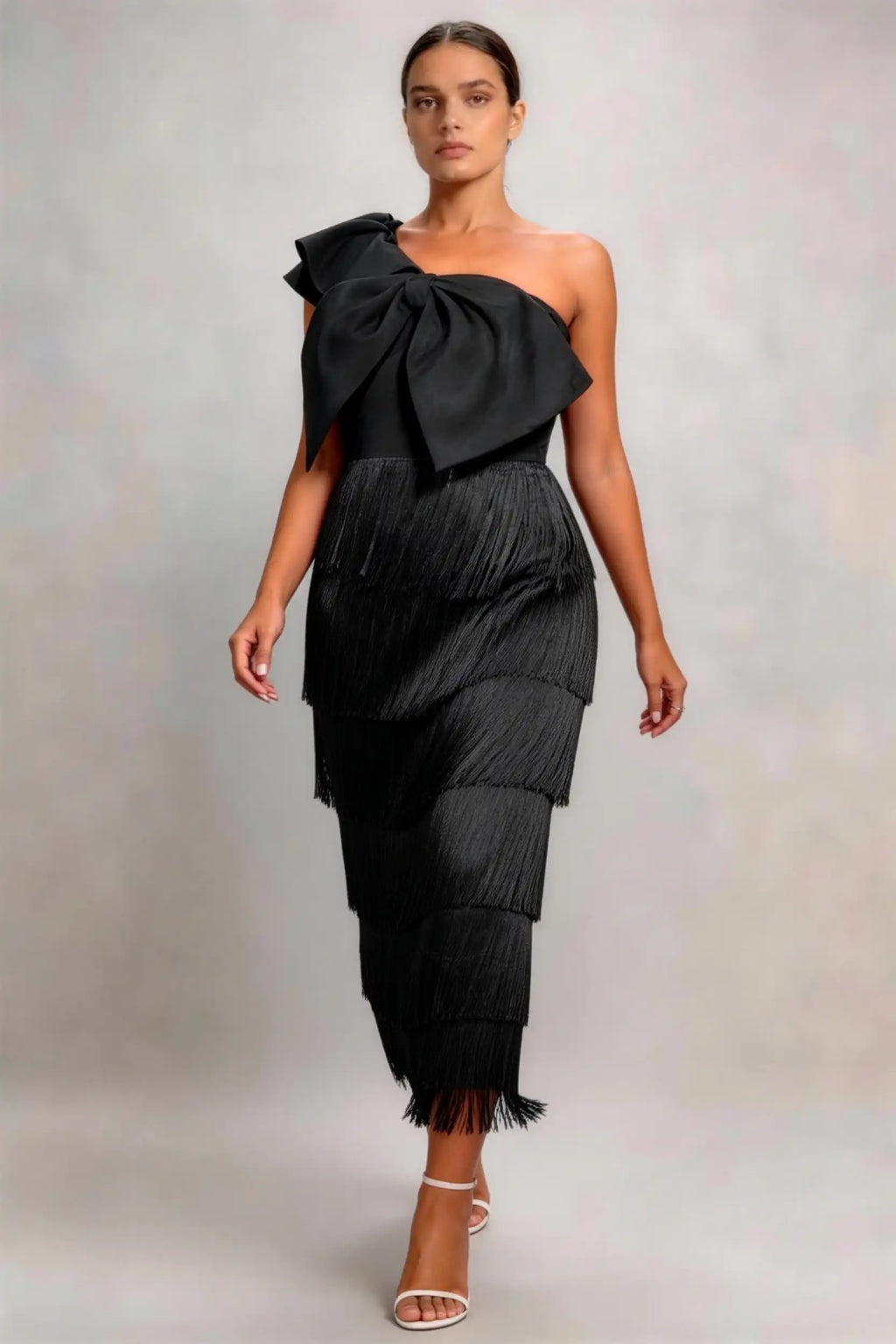 Phoehua Walking‑Pose Front View of Black Vintage Fringe Evening Dress, One‑Shoulder Oversized‑Bow Tiered‑Tassel Asymmetrical‑Neck Slim Party Midi Dress
