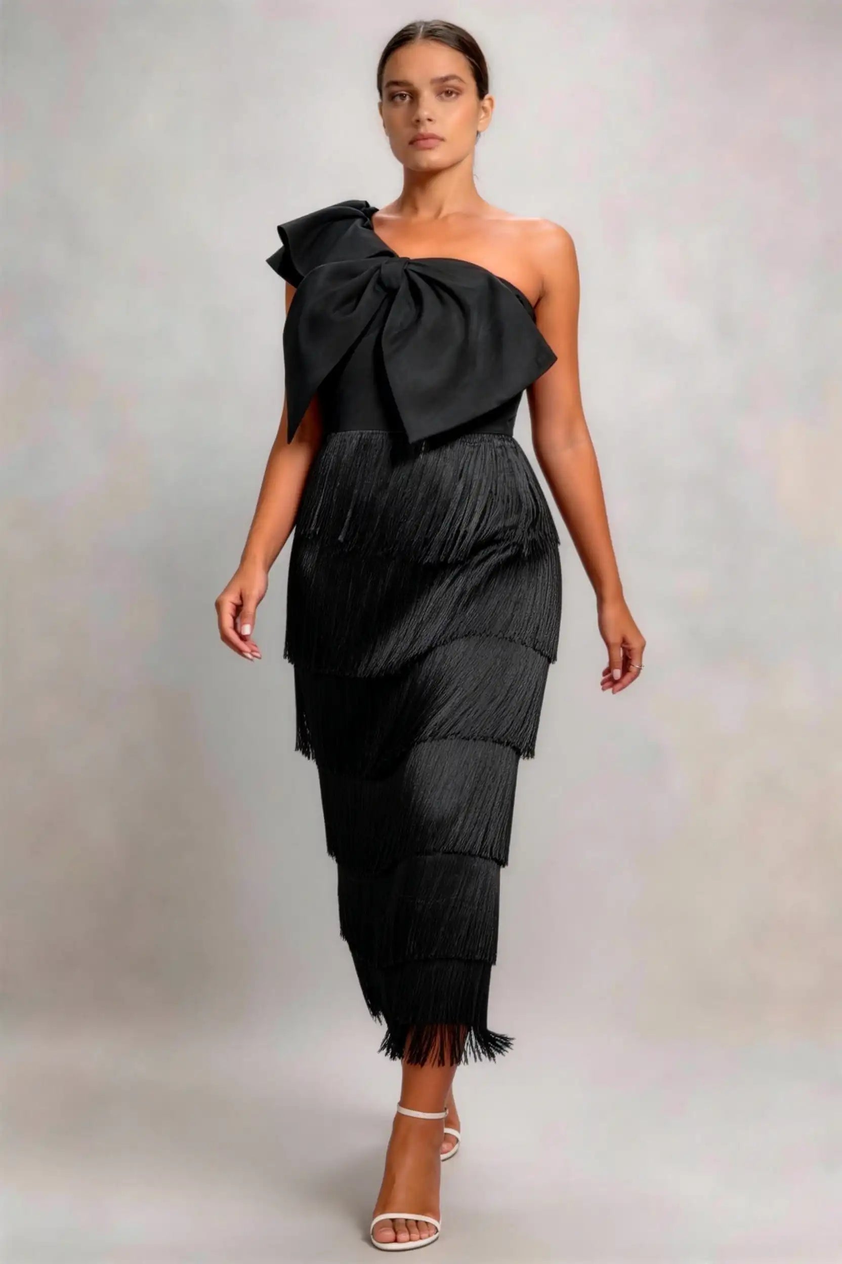 Phoehua Walking‑Pose Front View of Black Vintage Fringe Evening Dress, One‑Shoulder Oversized‑Bow Tiered‑Tassel Asymmetrical‑Neck Slim Party Midi Dress