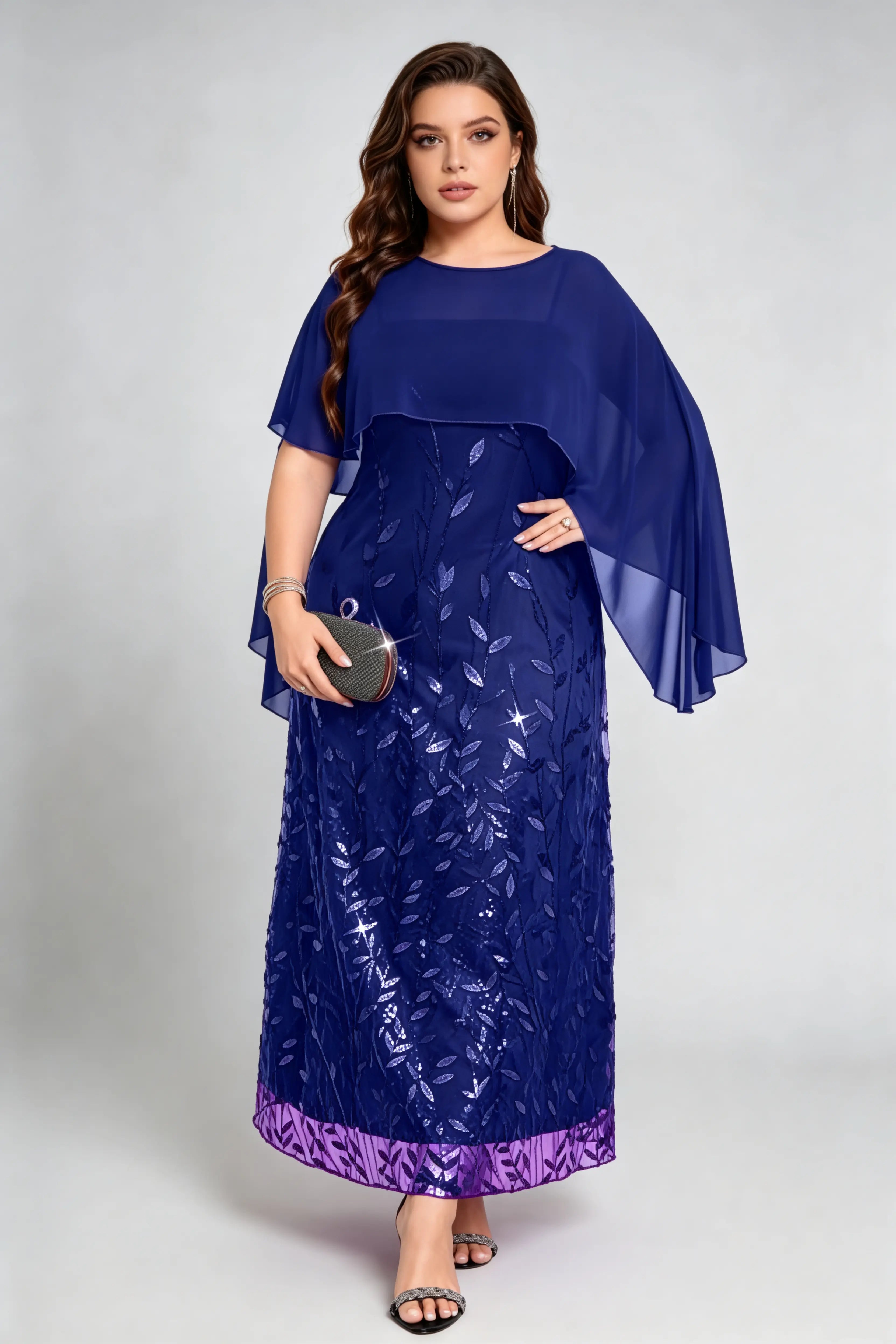 Curvy model wearing plus size navy sequin leaf embroidered chiffon capelet maxi dress