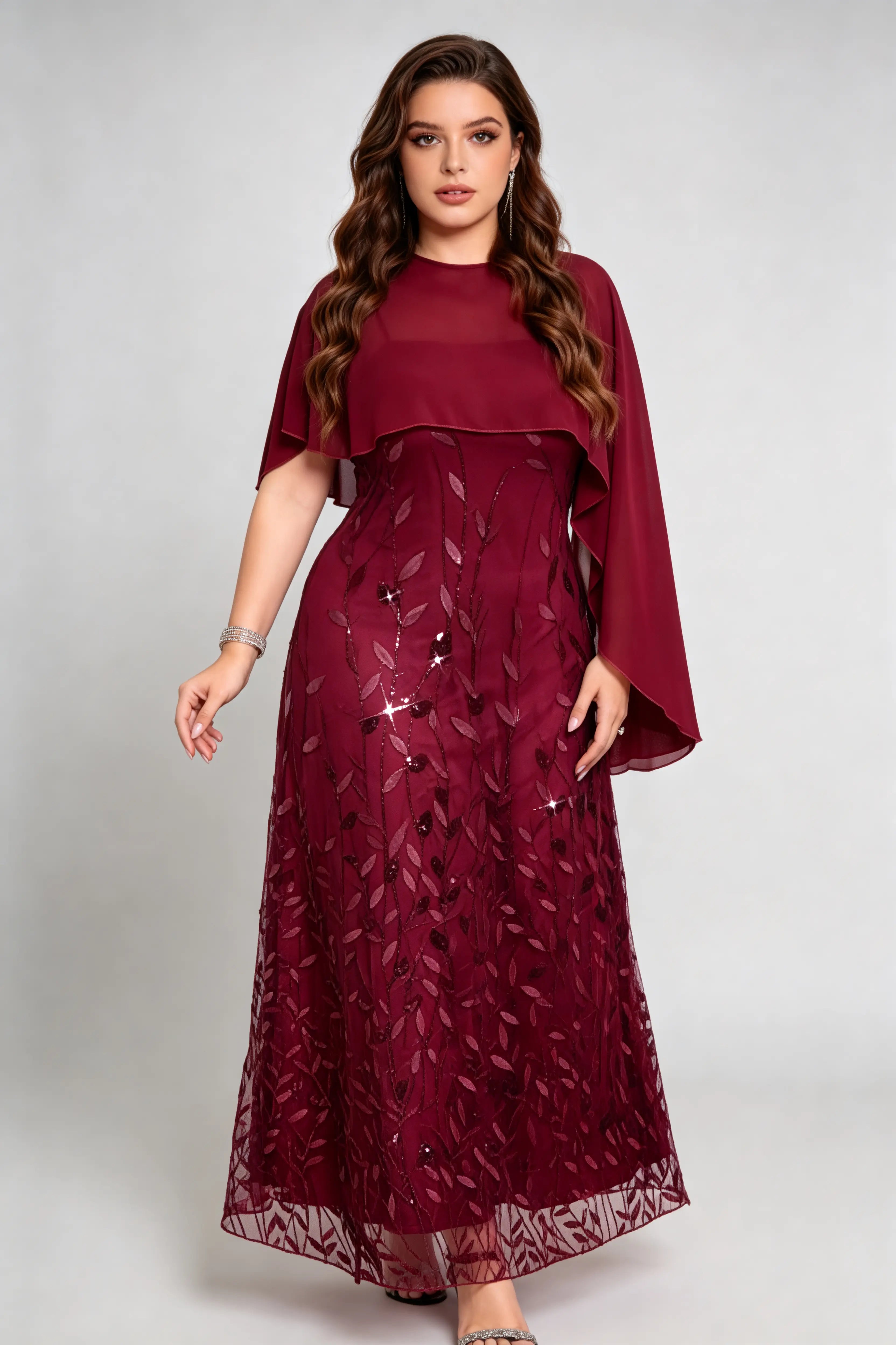 Curvy model wearing plus size burgundy sequin leaf embroidered chiffon capelet maxi dress