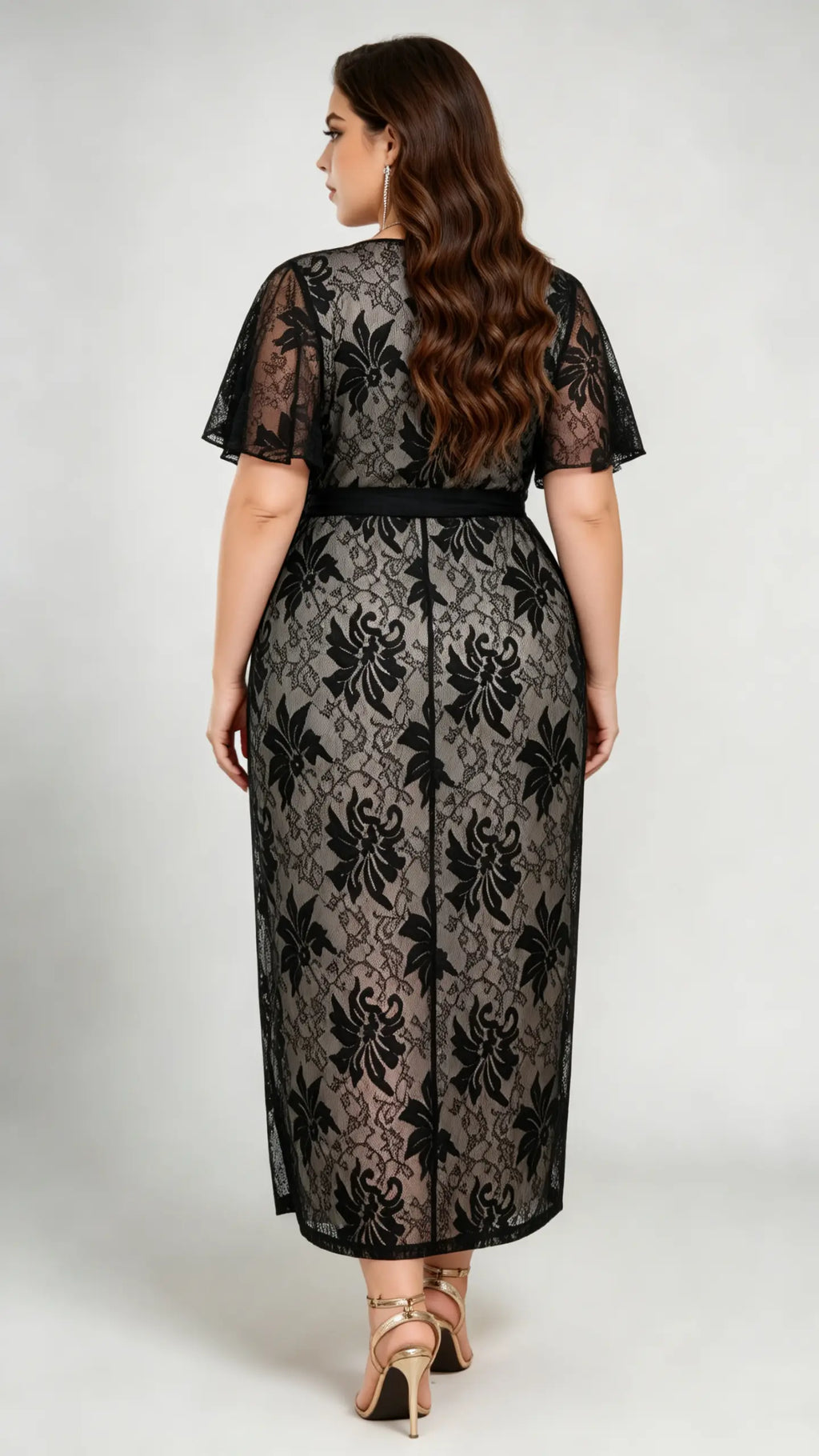 Back view of plus size black lace midi dress, showcasing flutter sleeves and tie waist design