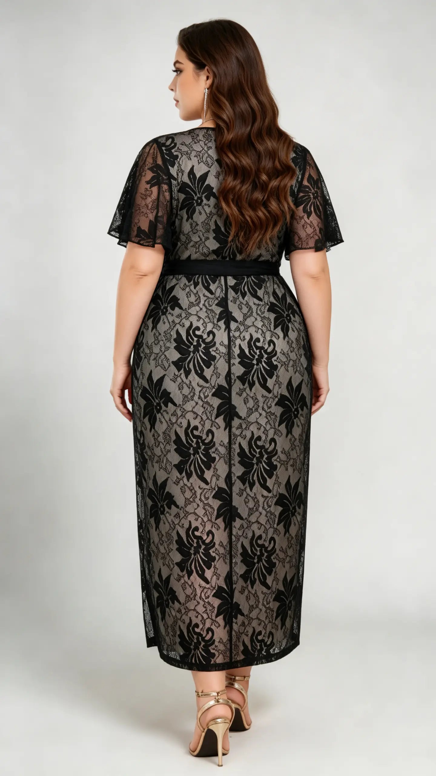 Back view of plus size black lace midi dress, showcasing flutter sleeves and tie waist design