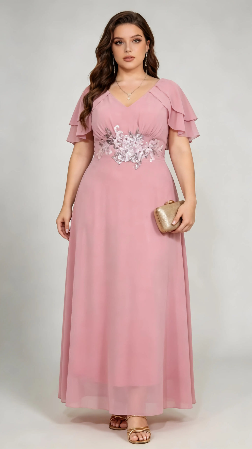 Plus size woman wearing pink floral embroidered chiffon maxi dress with ruffled sleeves, full length view
