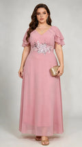 Plus size woman wearing pink floral embroidered chiffon maxi dress with ruffled sleeves, full length view