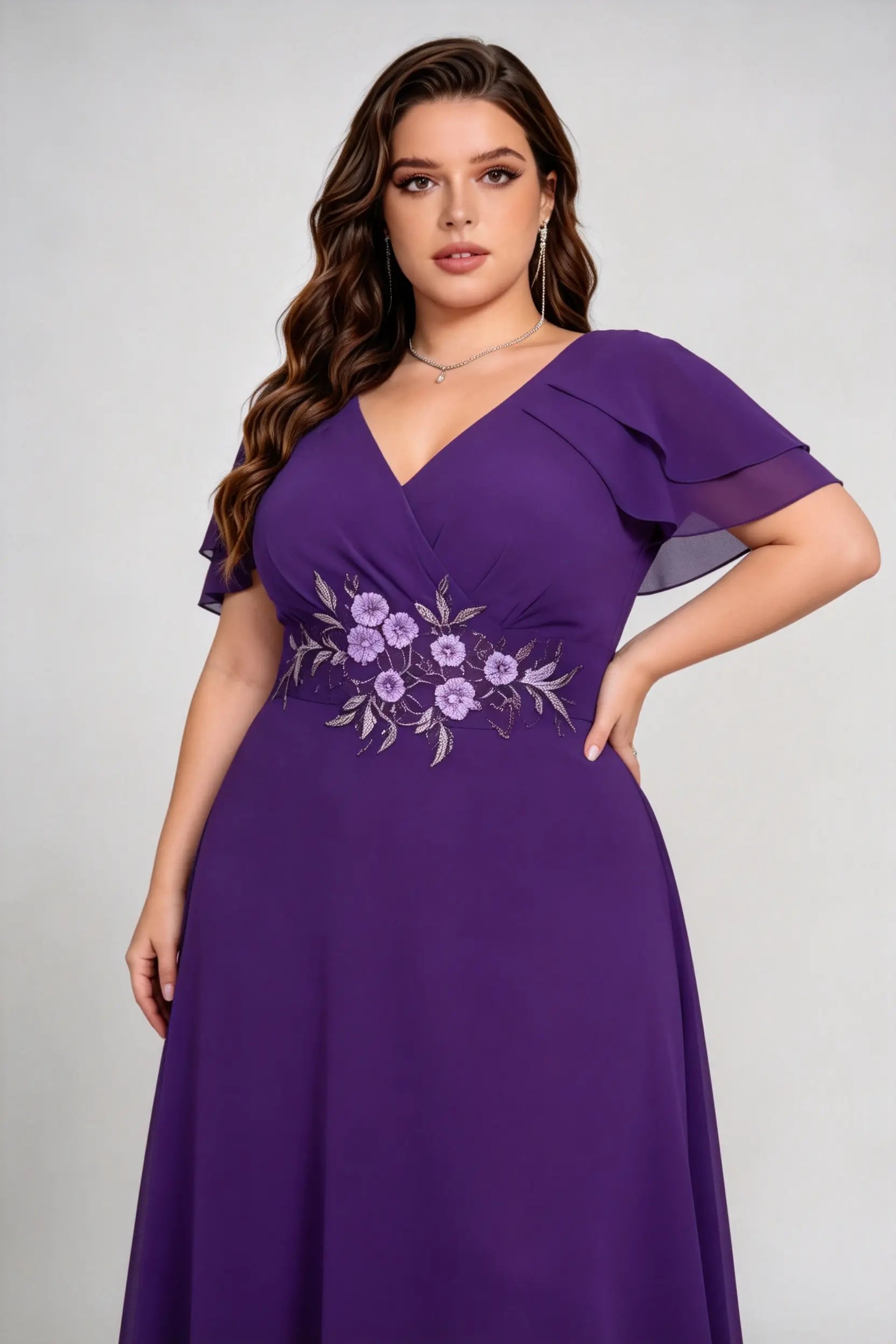 Plus size woman wearing purple floral embroidered chiffon maxi dress with ruffled sleeves, full length view