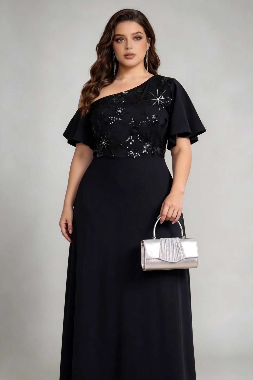 Plus size woman wearing black one-shoulder sequin evening gown with silver clutch bag, full-length view