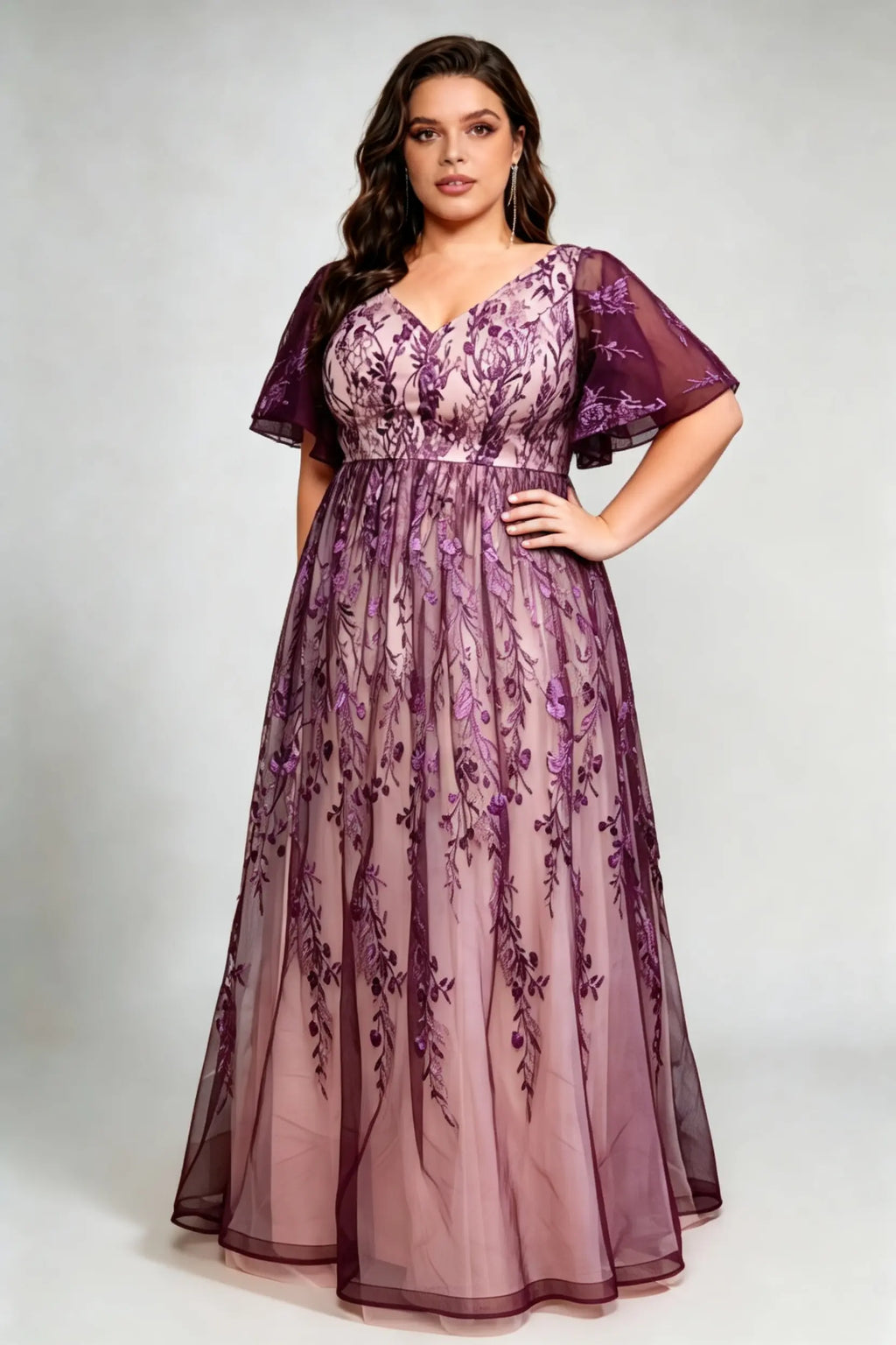 Curvy model wearing plus size v-neck embroidered mesh maxi dress - elegant purple floral flutter sleeve evening gown