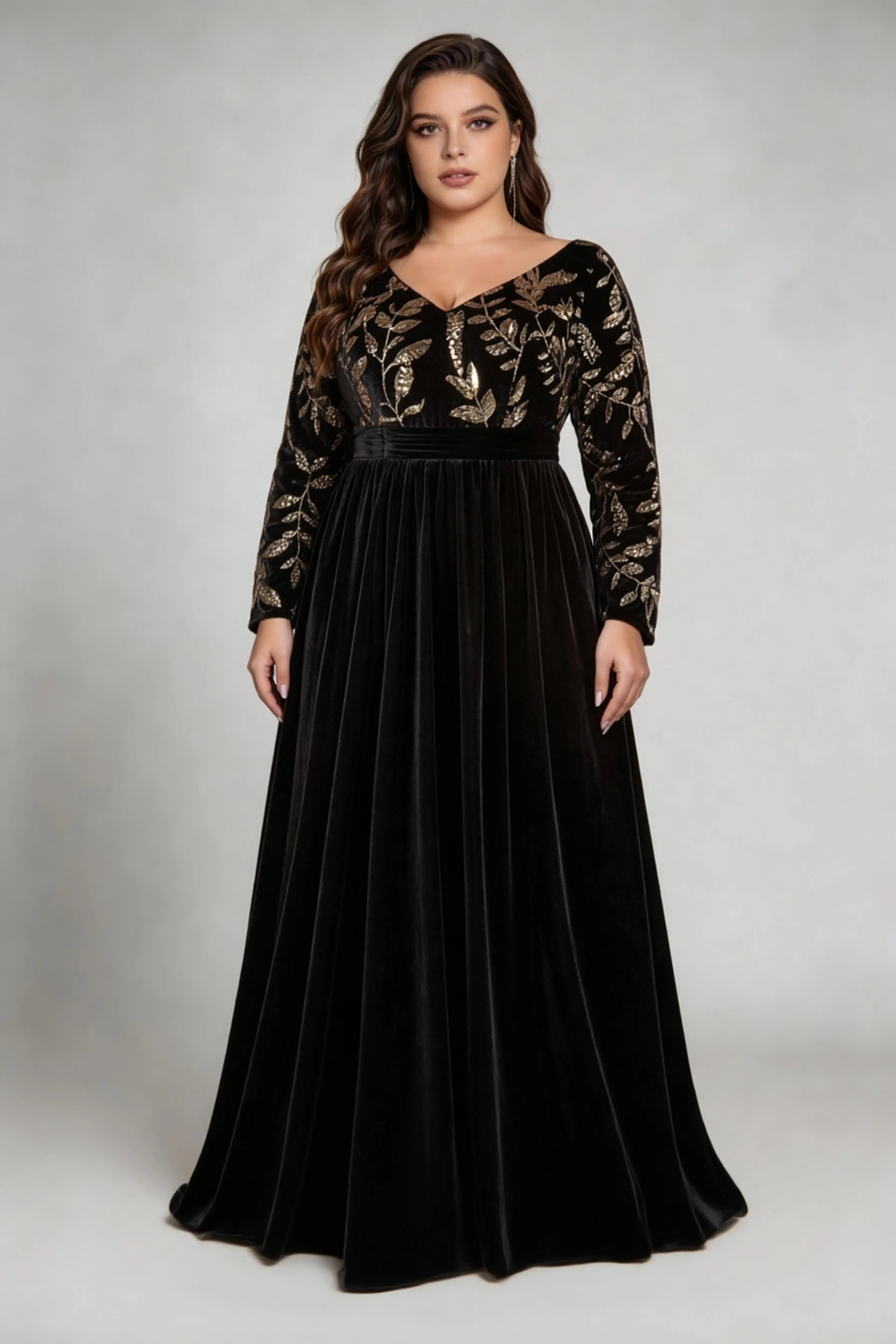Curvy model wearing plus size black elegant v-neck velvet maxi dress with gold floral embroidery