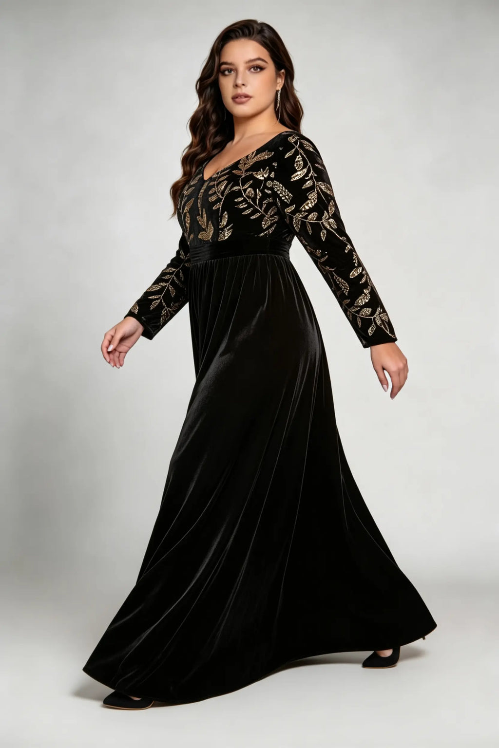 Curvy model wearing plus size black elegant v-neck velvet maxi dress with gold floral embroidery