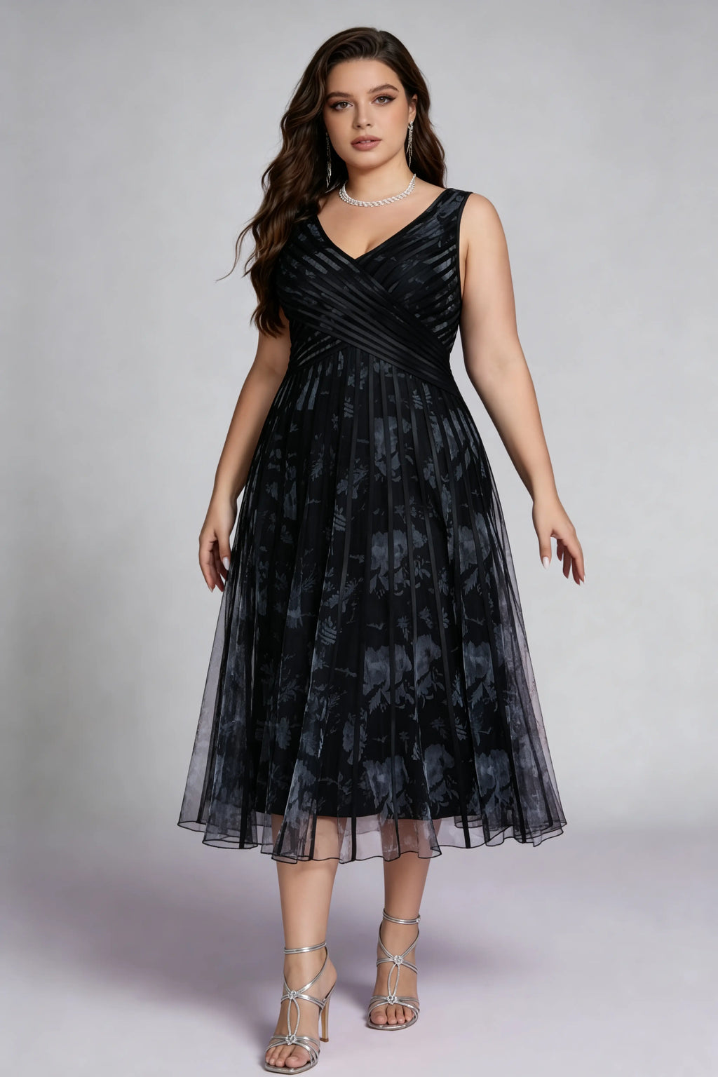 Curvy model wearing plus size black surplice v-neck floral mesh midi dress