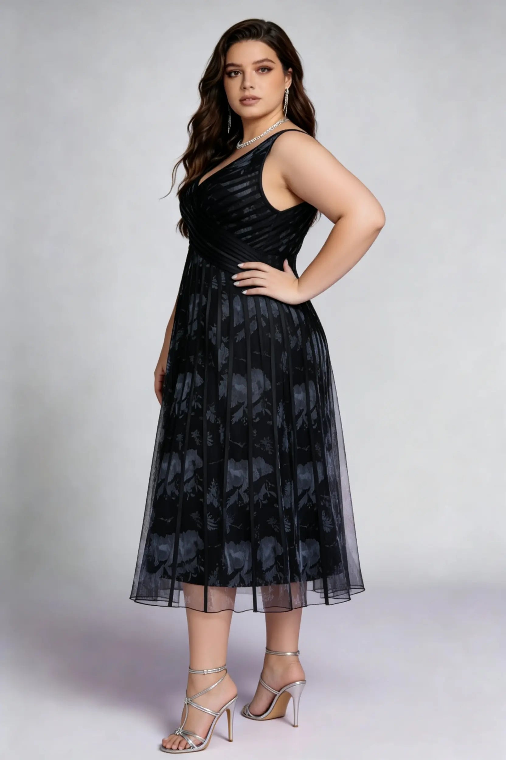 Curvy model wearing plus size black surplice v-neck floral mesh midi dress