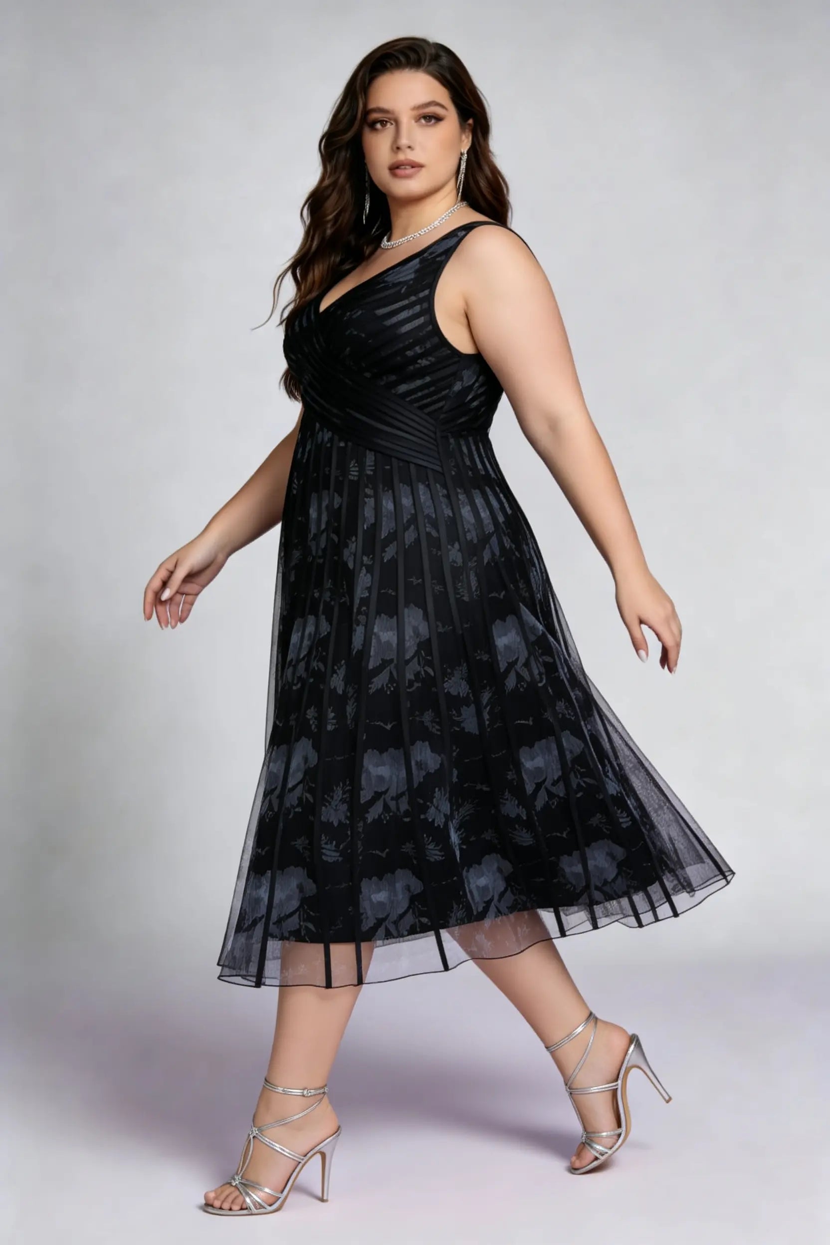 Curvy model wearing plus size black surplice v-neck floral mesh midi dress