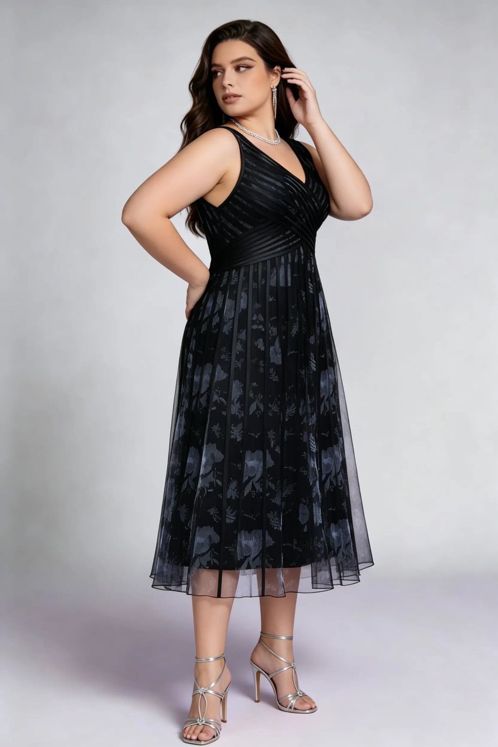 Curvy model wearing plus size black surplice v-neck floral mesh midi dress