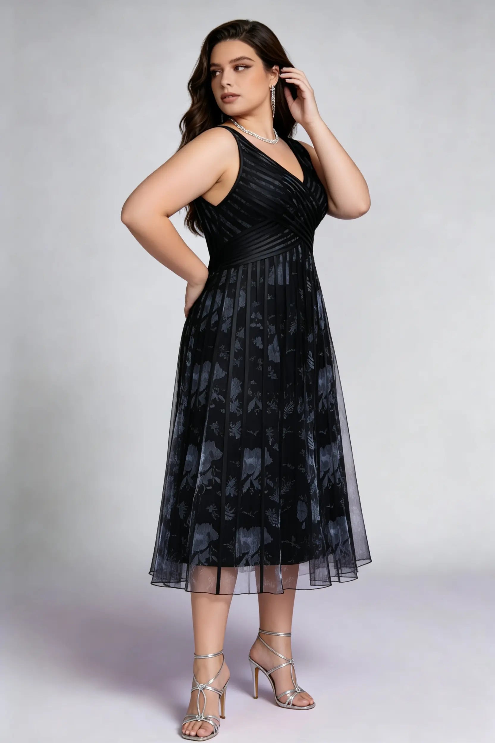 Curvy model wearing plus size black surplice v-neck floral mesh midi dress