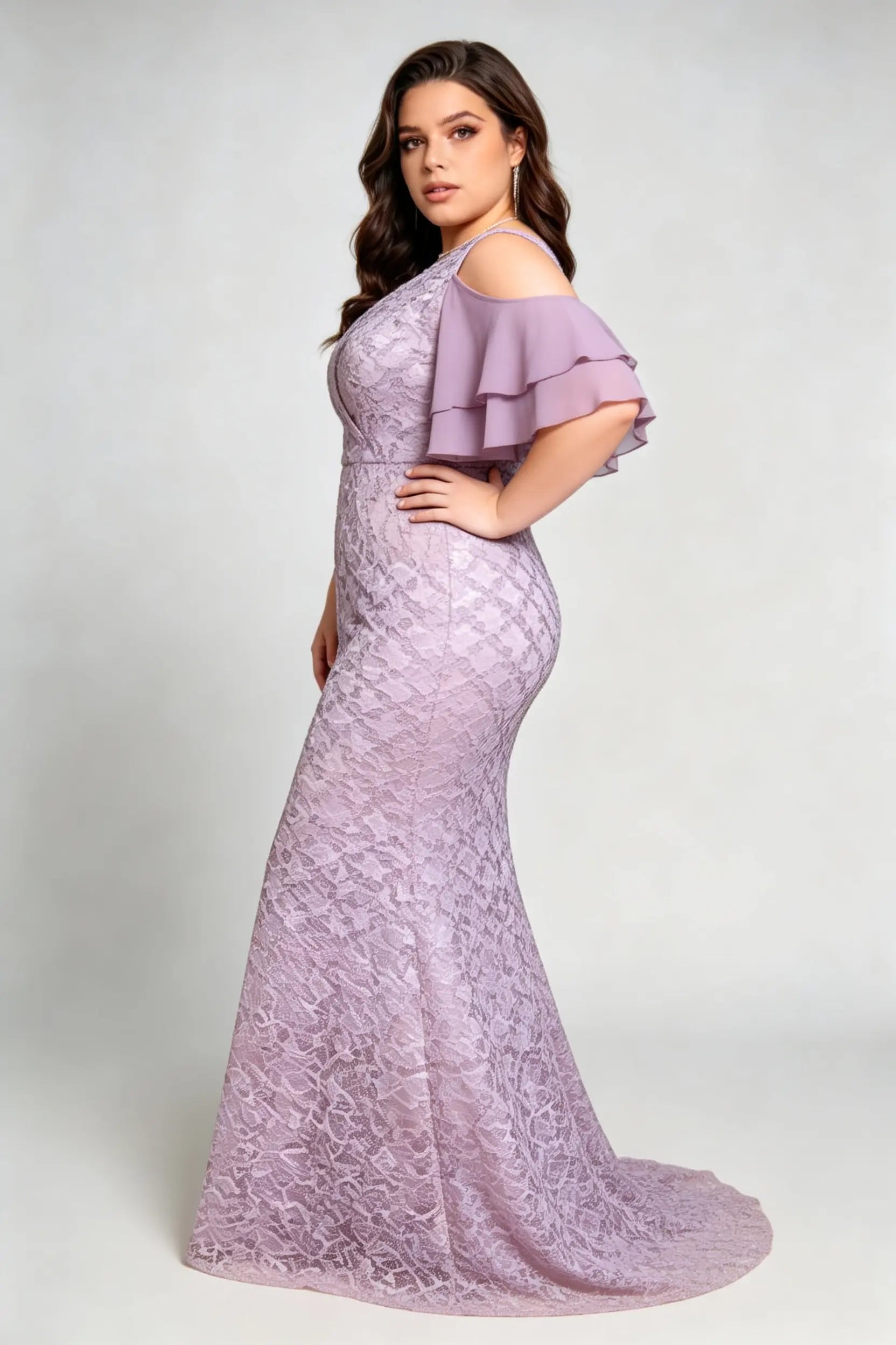 Curvy model wearing plus size purple cold-shoulder lace mermaid evening gown with tiered flutter sleeves