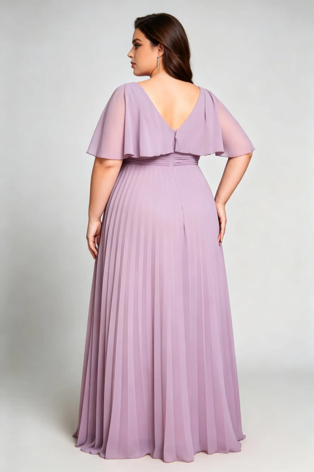 Curvy model wearing plus size purple v-neck pleated chiffon maxi evening dress with flutter sleeves