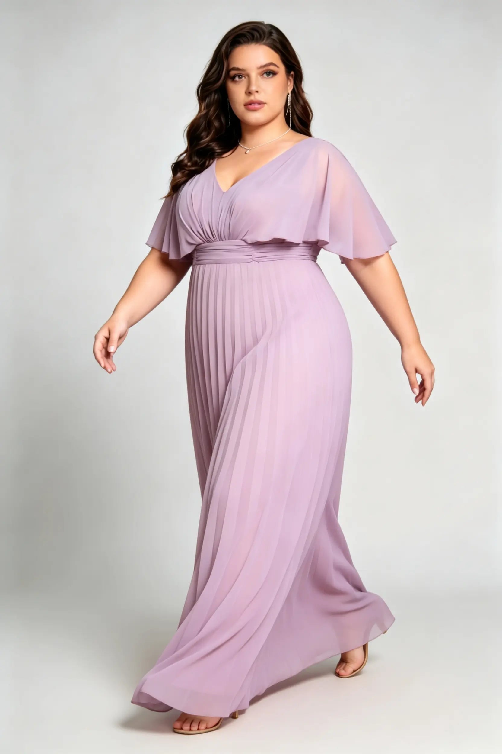 Curvy model wearing plus size purple v-neck pleated chiffon maxi evening dress with flutter sleeves