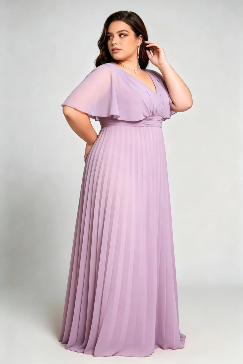 Curvy model wearing plus size purple v-neck pleated chiffon maxi evening dress with flutter sleeves