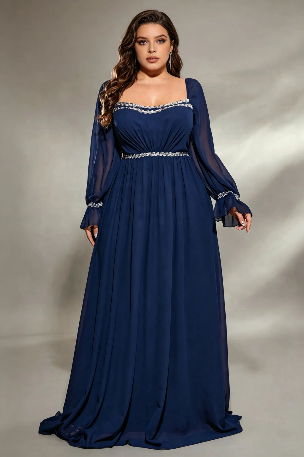 Curvy model wearing plus size navy square neck chiffon maxi evening gown with beaded trim and lace-up back