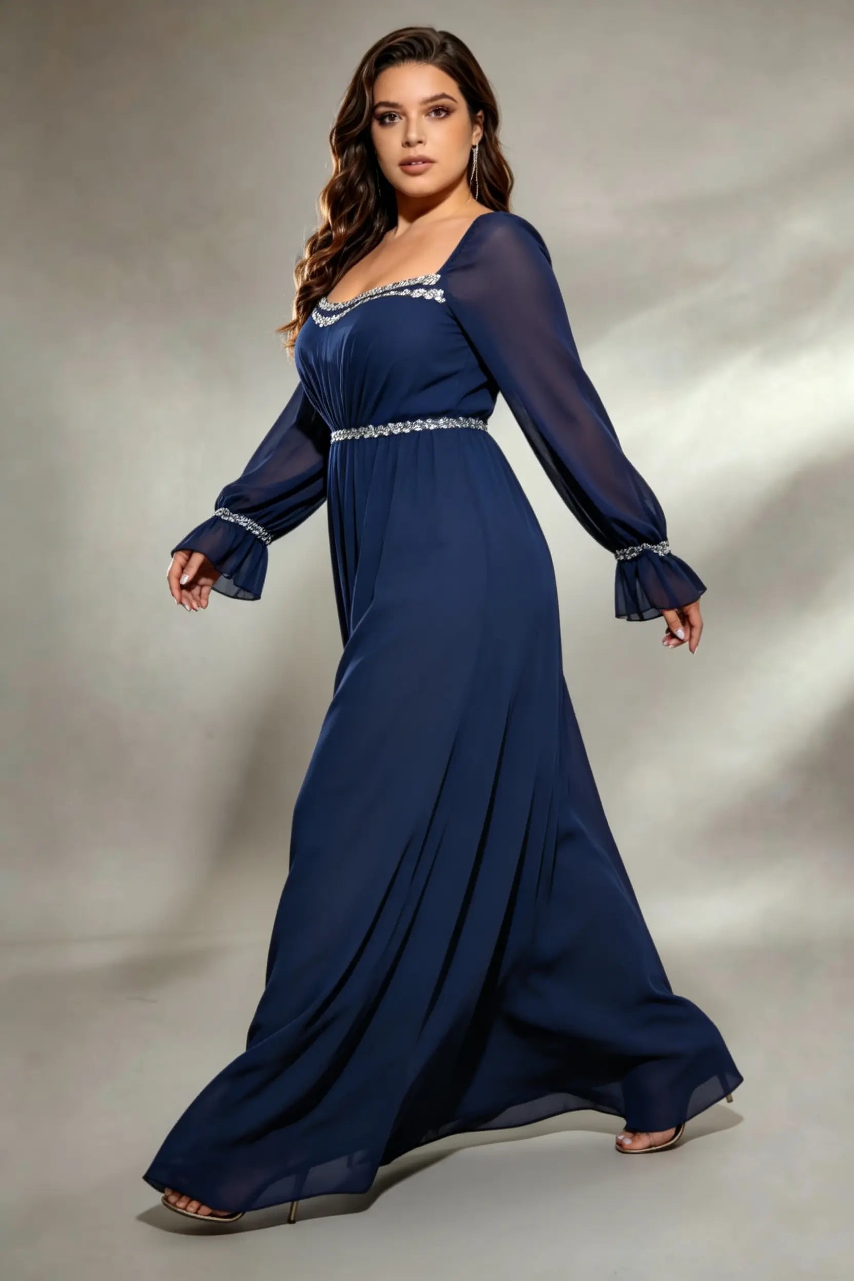 Curvy model wearing plus size navy square neck chiffon maxi evening gown with beaded trim and lace-up back