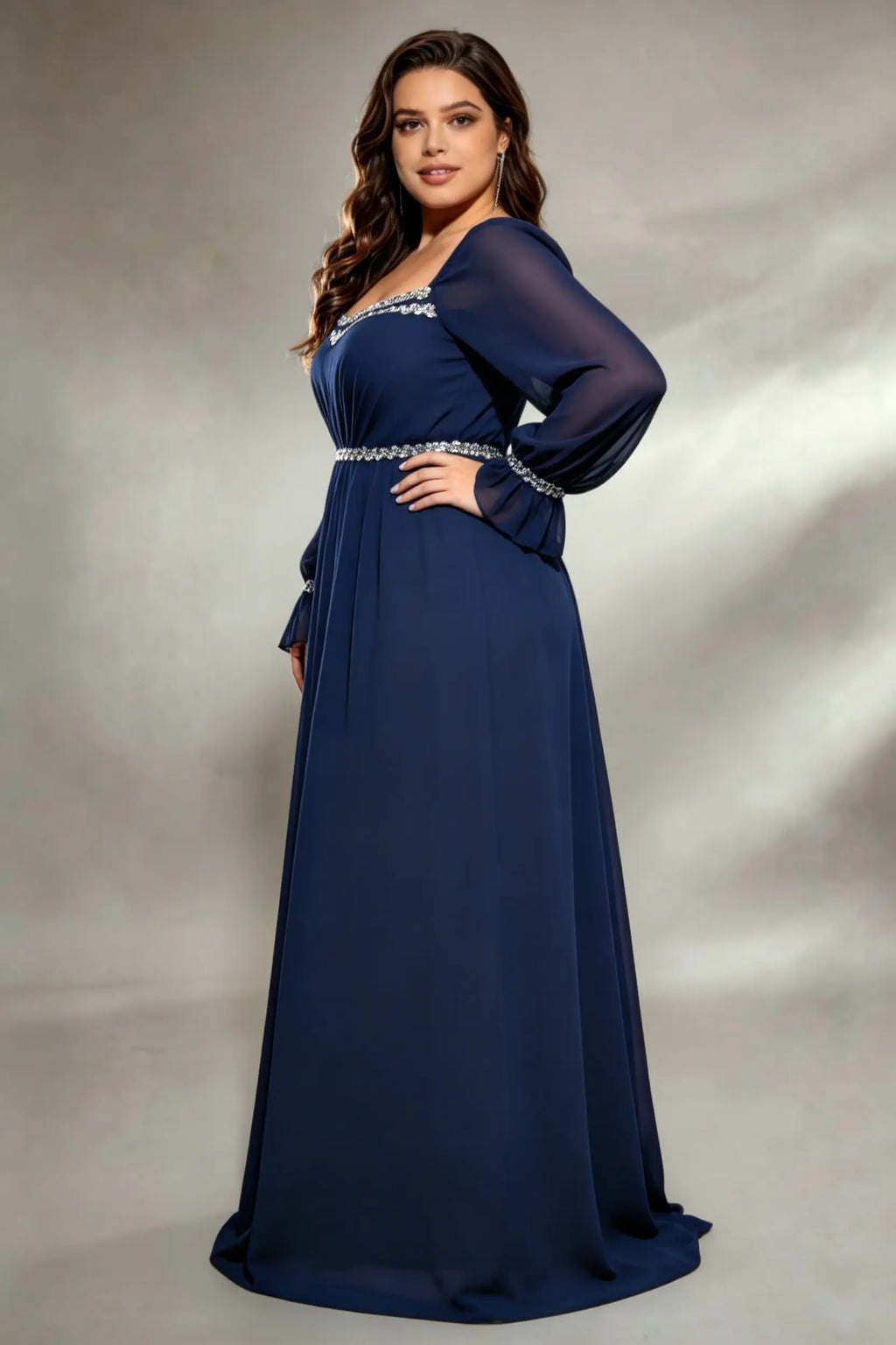 Curvy model wearing plus size navy square neck chiffon maxi evening gown with beaded trim and lace-up back