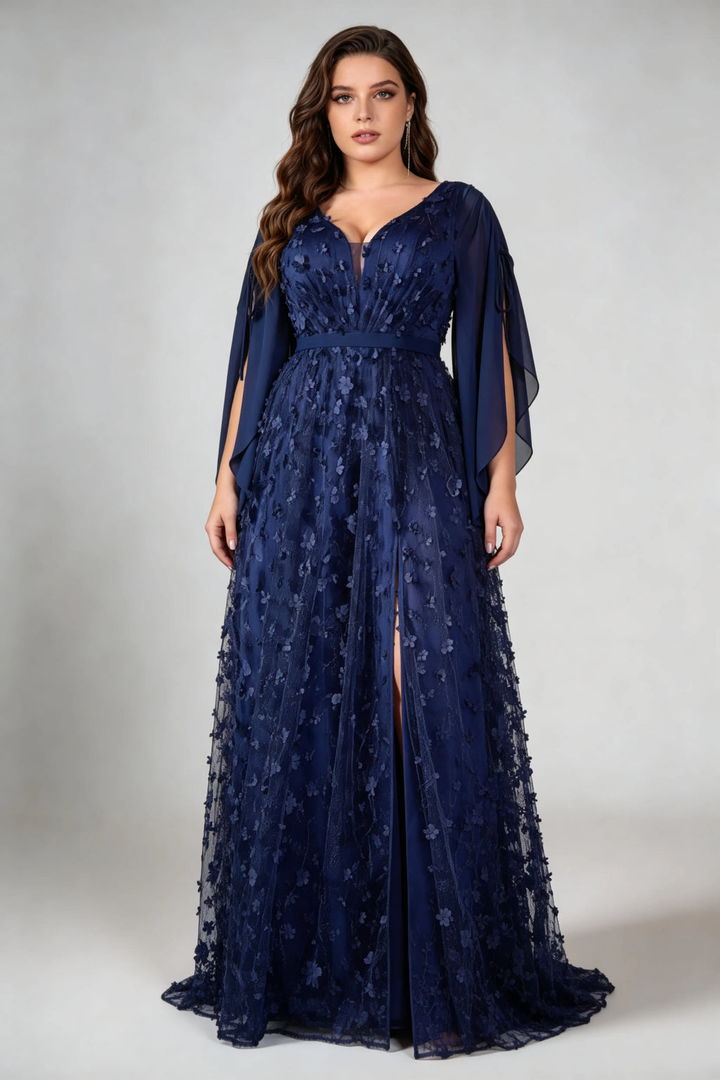 Curvy model wearing plus size navy blue 3d floral applique evening gown – elegant v-neck cape sleeve formal maxi dress with slit (xl-4xl)