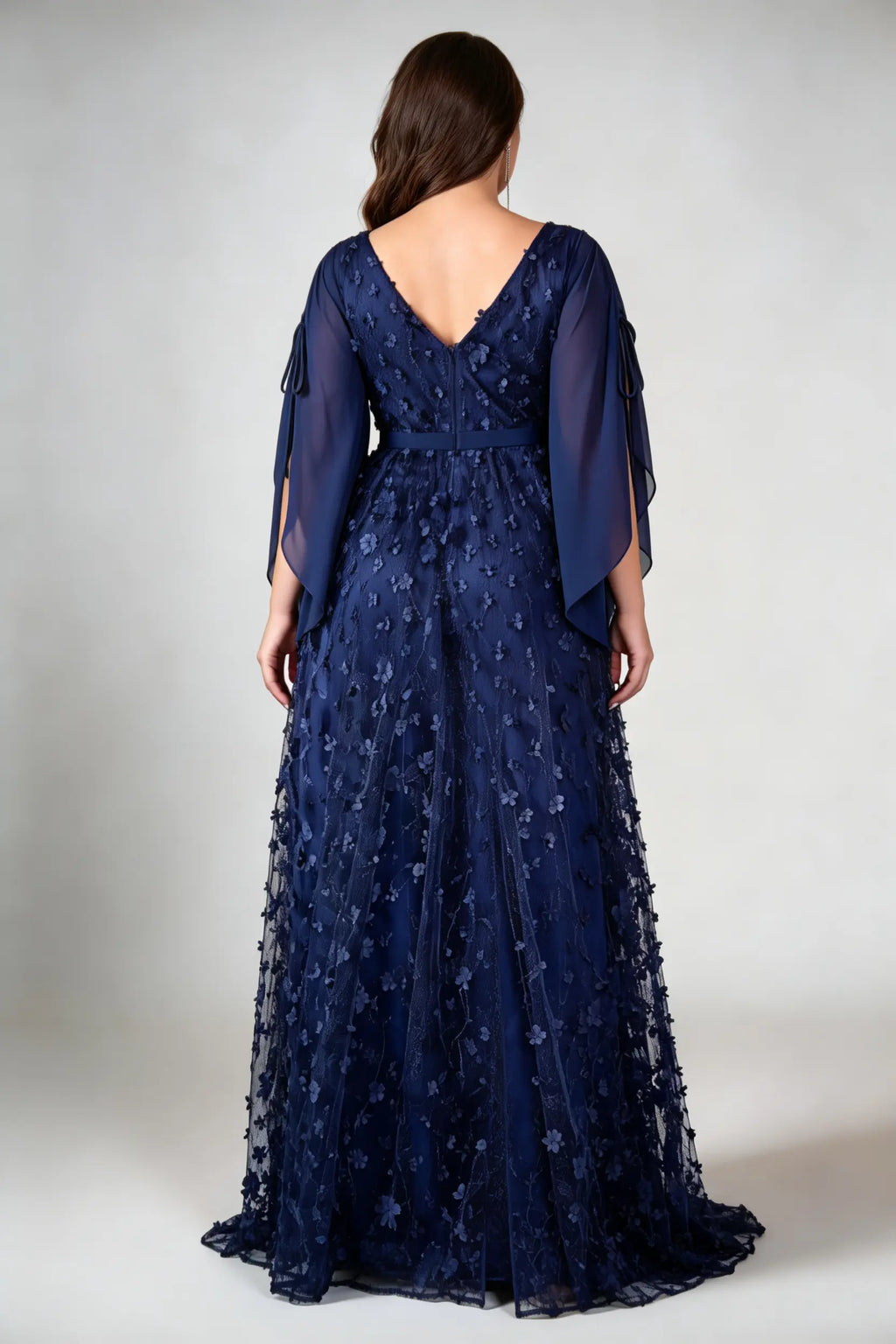 Curvy model wearing plus size navy blue 3d floral applique evening gown – elegant v-neck cape sleeve formal maxi dress with slit (xl-4xl)