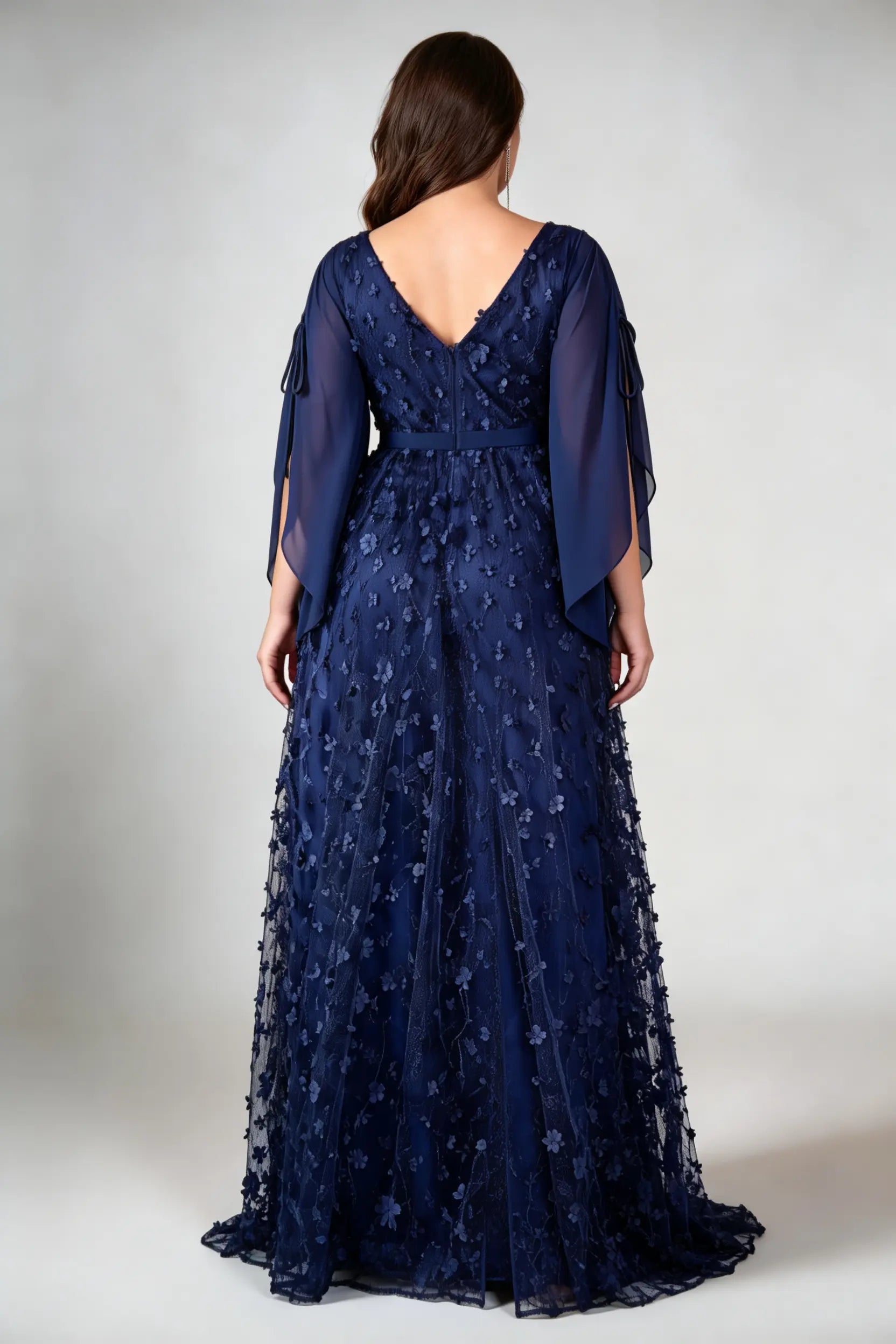 Curvy model wearing plus size navy blue 3d floral applique evening gown – elegant v-neck cape sleeve formal maxi dress with slit (xl-4xl)