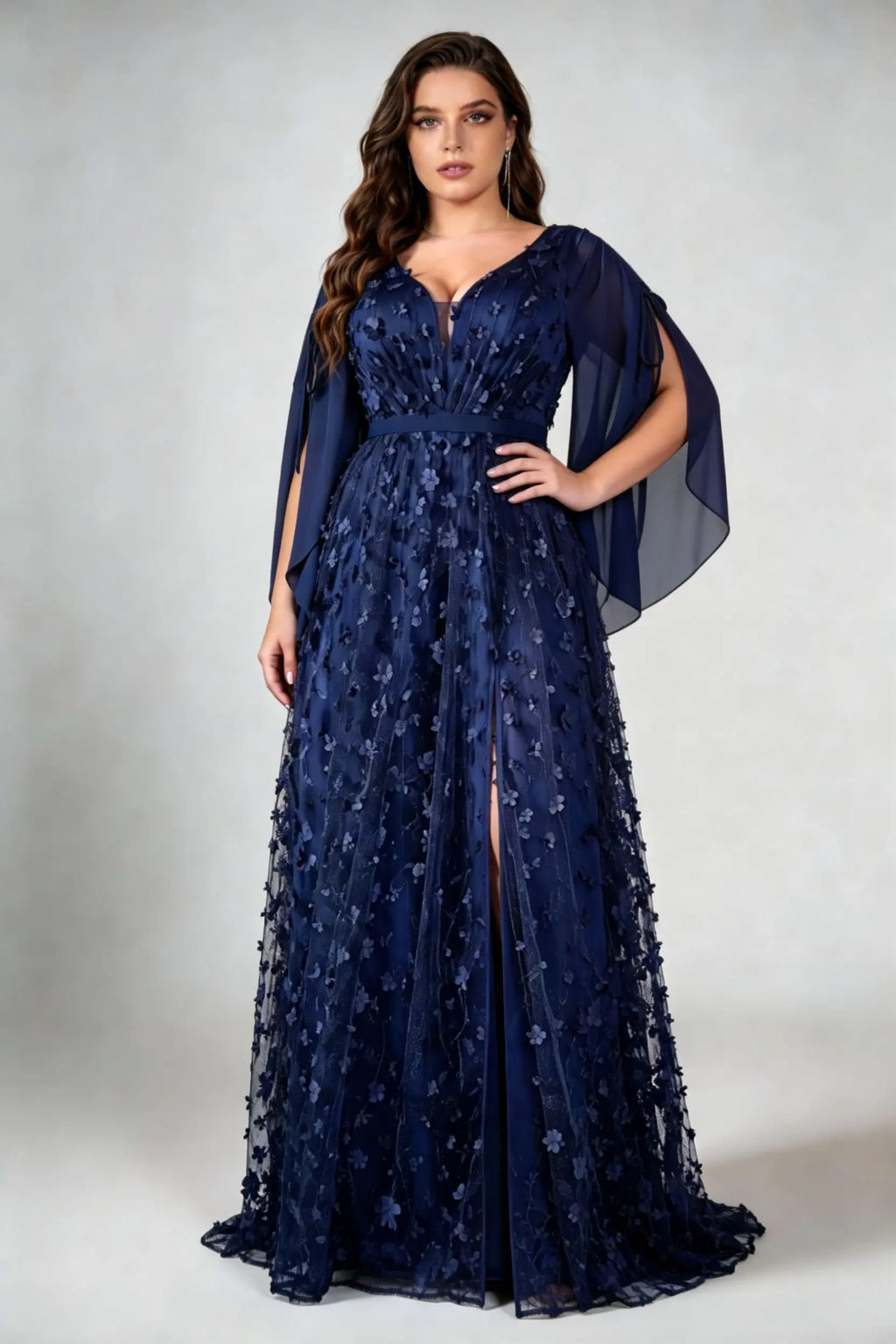 Curvy model wearing plus size navy blue 3d floral applique evening gown – elegant v-neck cape sleeve formal maxi dress with slit (xl-4xl)