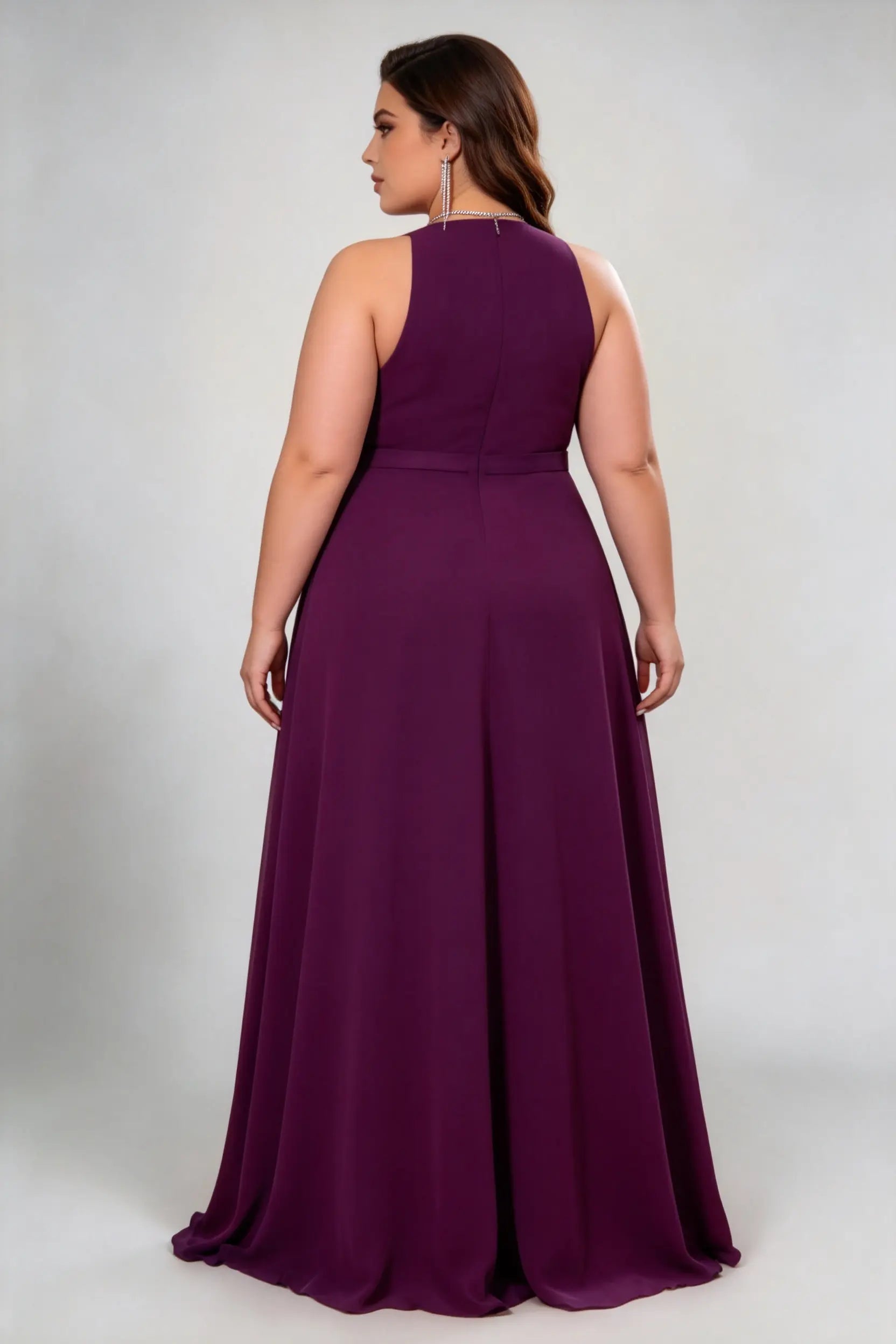 Curvy model wearing plus size burgundy dark plum halter neck evening gown – elegant pleated chiffon a-line formal maxi dress