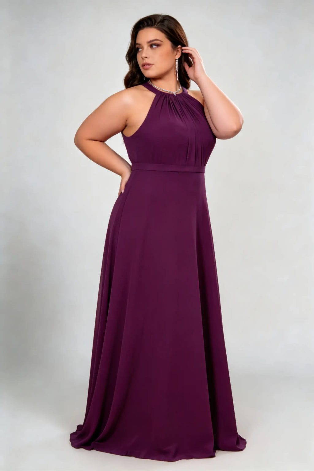 Curvy model wearing plus size burgundy dark plum halter neck evening gown – elegant pleated chiffon a-line formal maxi dress