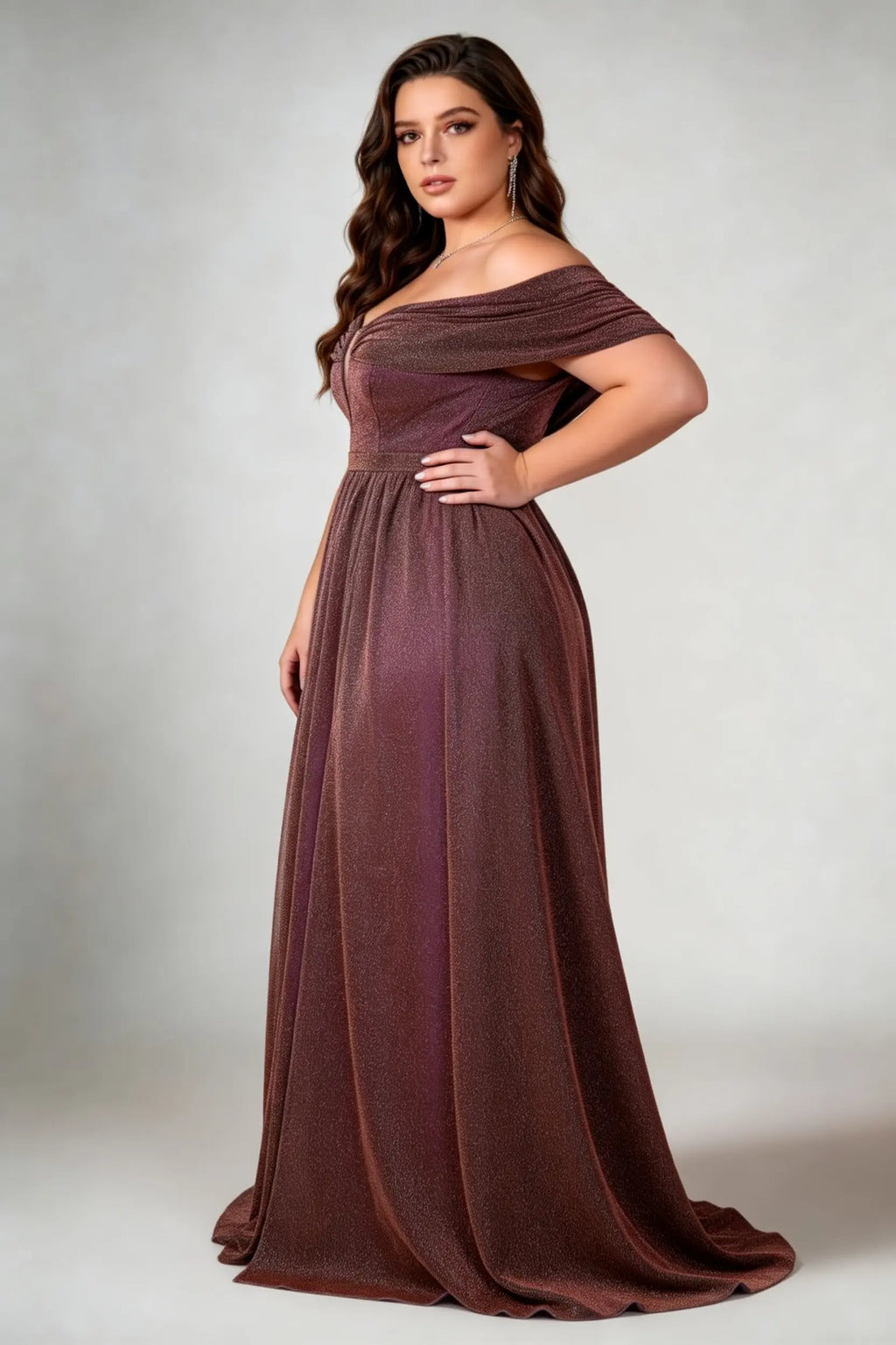 Curvy model wearing plus size brown shimmering off-the-shoulder evening gown – elegant metallic v-neck high slit formal maxi dress