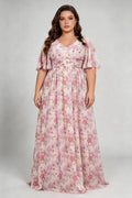Curvy model wearing plus size pink pastel floral print chiffon evening gown – elegant v-neck flutter sleeve formal maxi dress