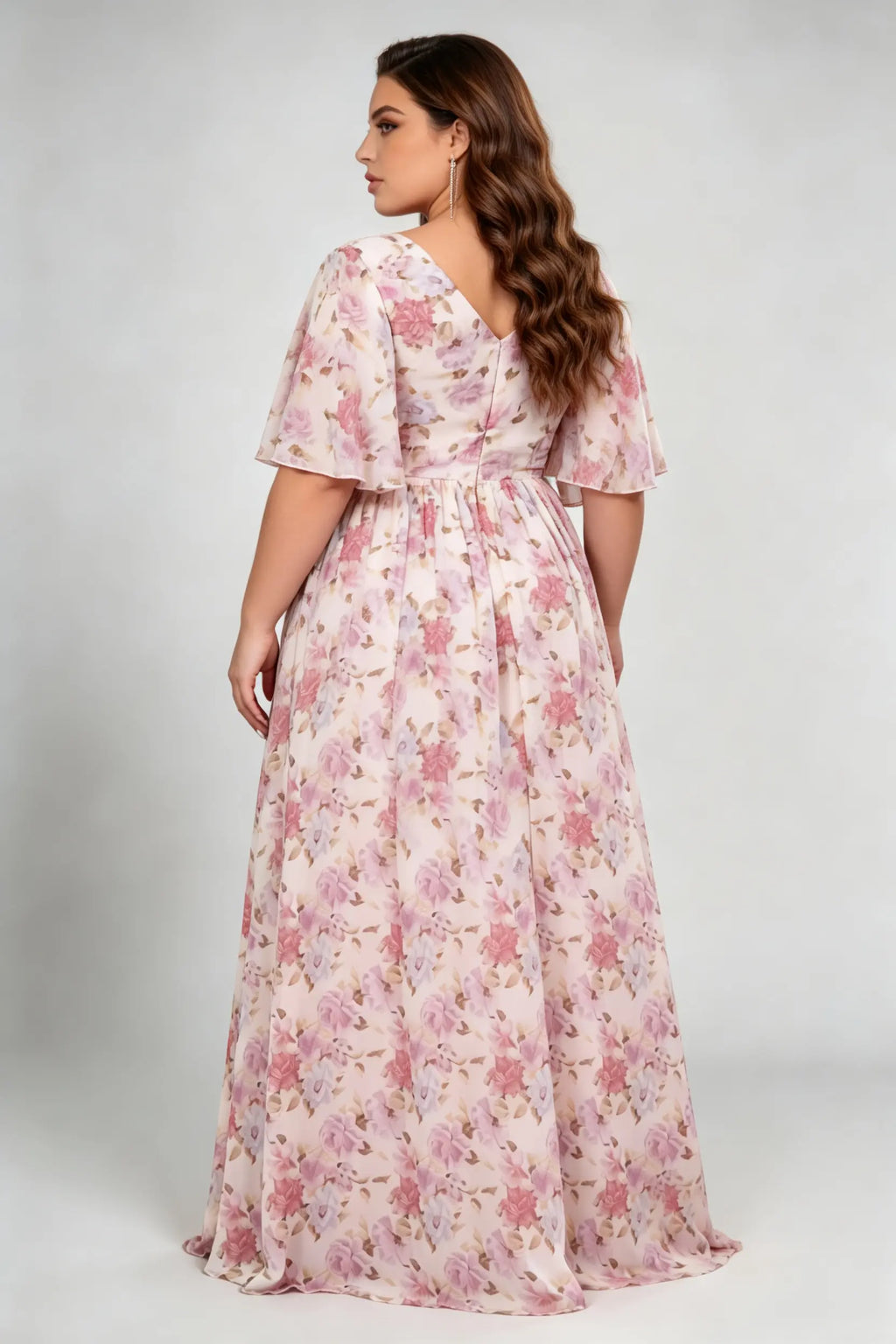 Curvy model wearing plus size pink pastel floral print chiffon evening gown – elegant v-neck flutter sleeve formal maxi dress