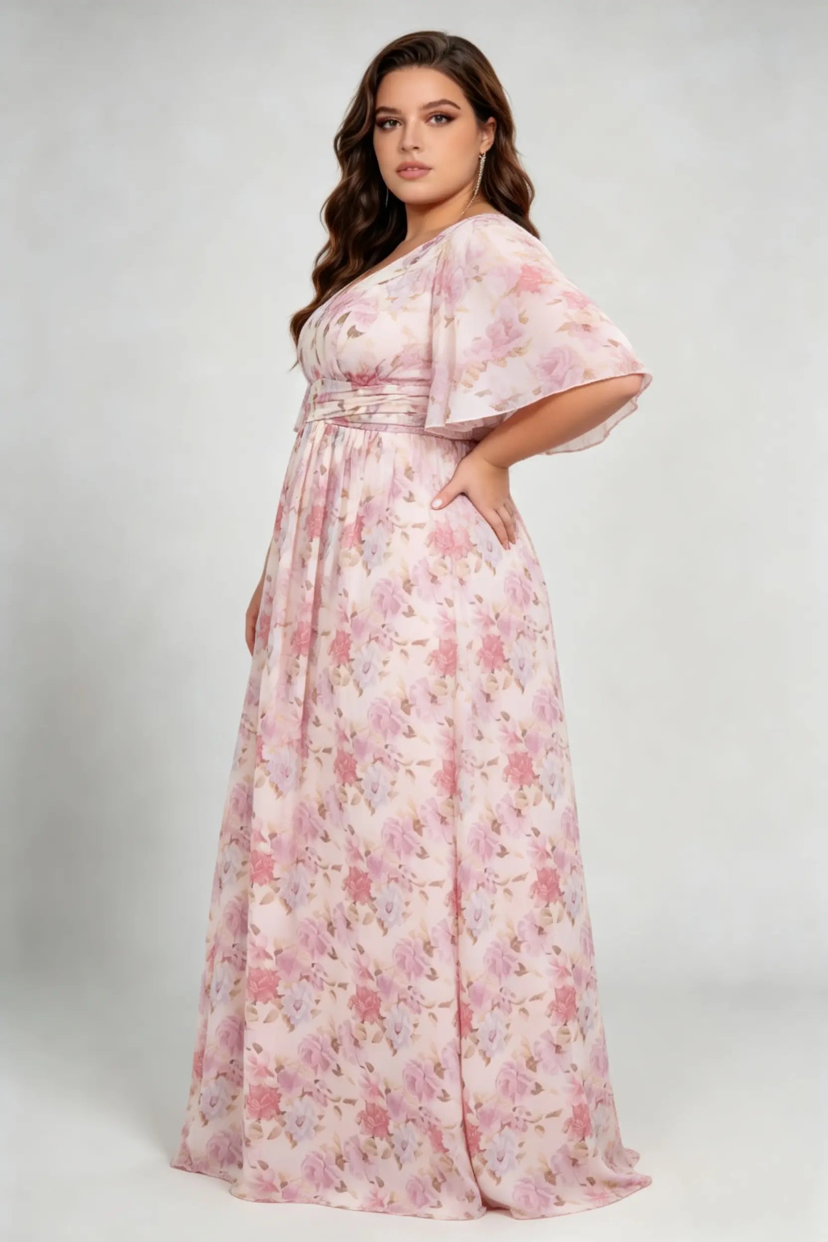 Curvy model wearing plus size pink pastel floral print chiffon evening gown – elegant v-neck flutter sleeve formal maxi dress