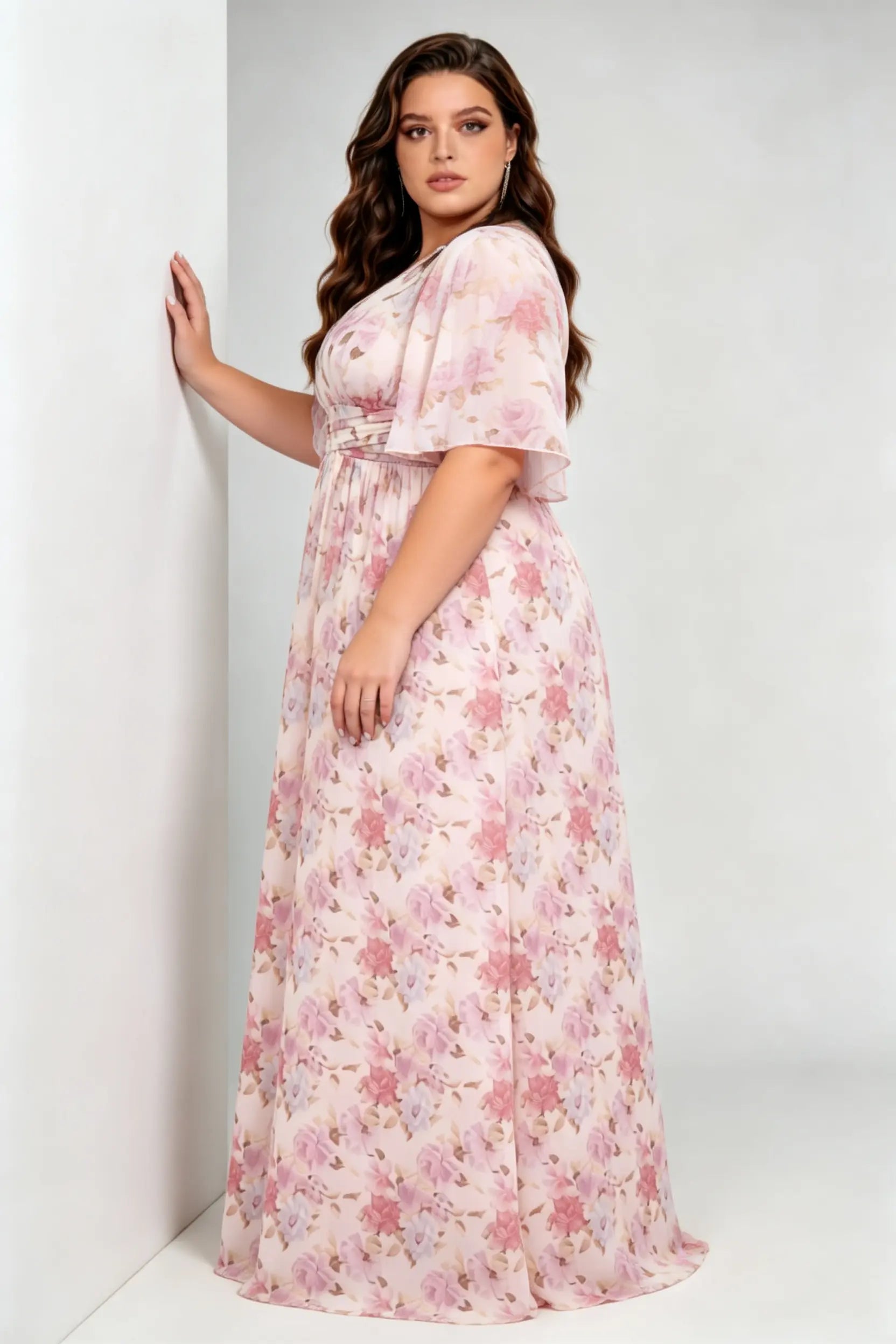 Curvy model wearing plus size pink pastel floral print chiffon evening gown – elegant v-neck flutter sleeve formal maxi dress