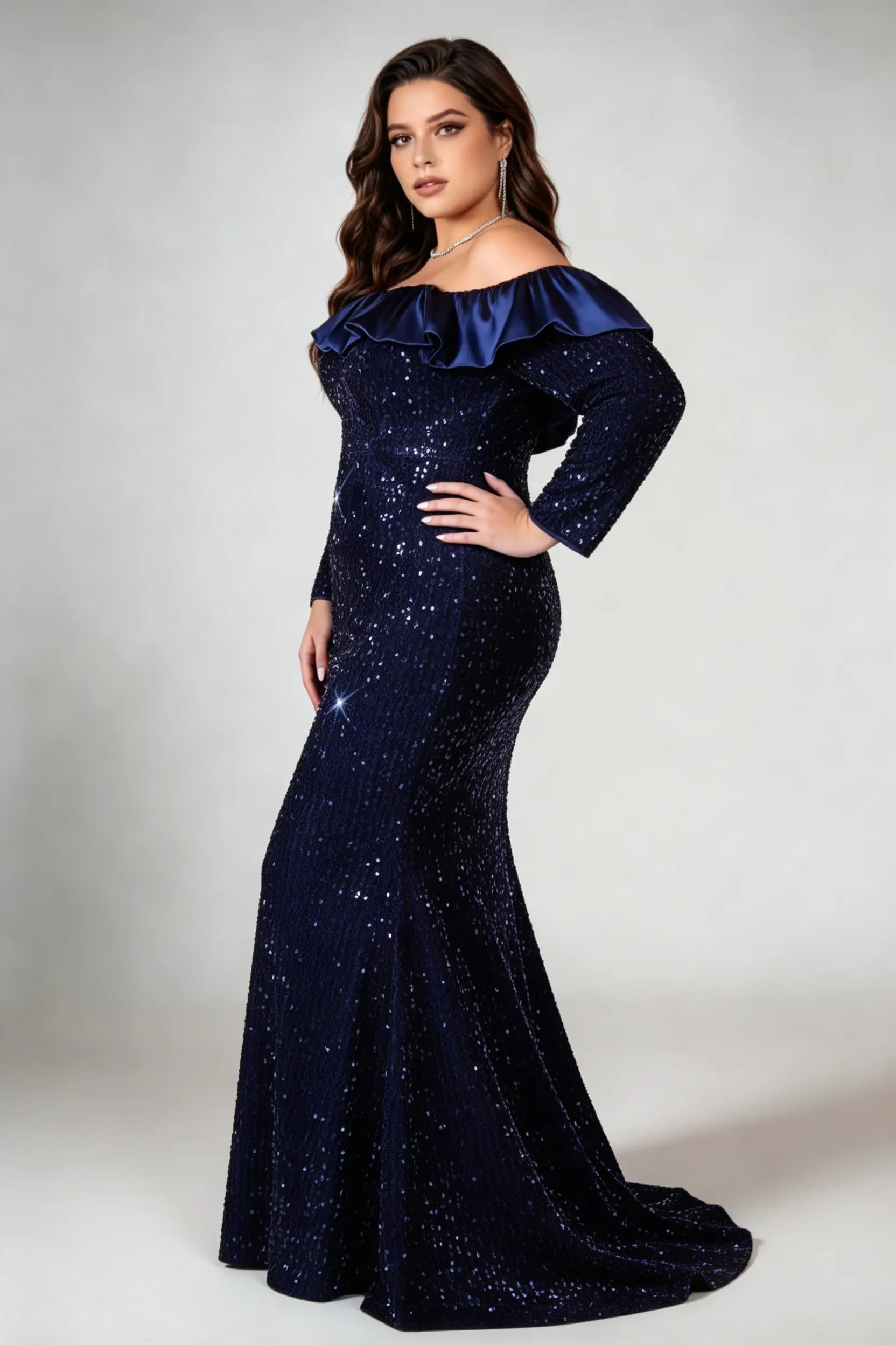 Curvy model wearing plus size navy off-the-shoulder sequin mermaid evening gown - elegant ruffle trim maxi dress