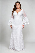 Curvy model wearing plus size v-neck white floral lace maxi dress with tiered bell sleeves