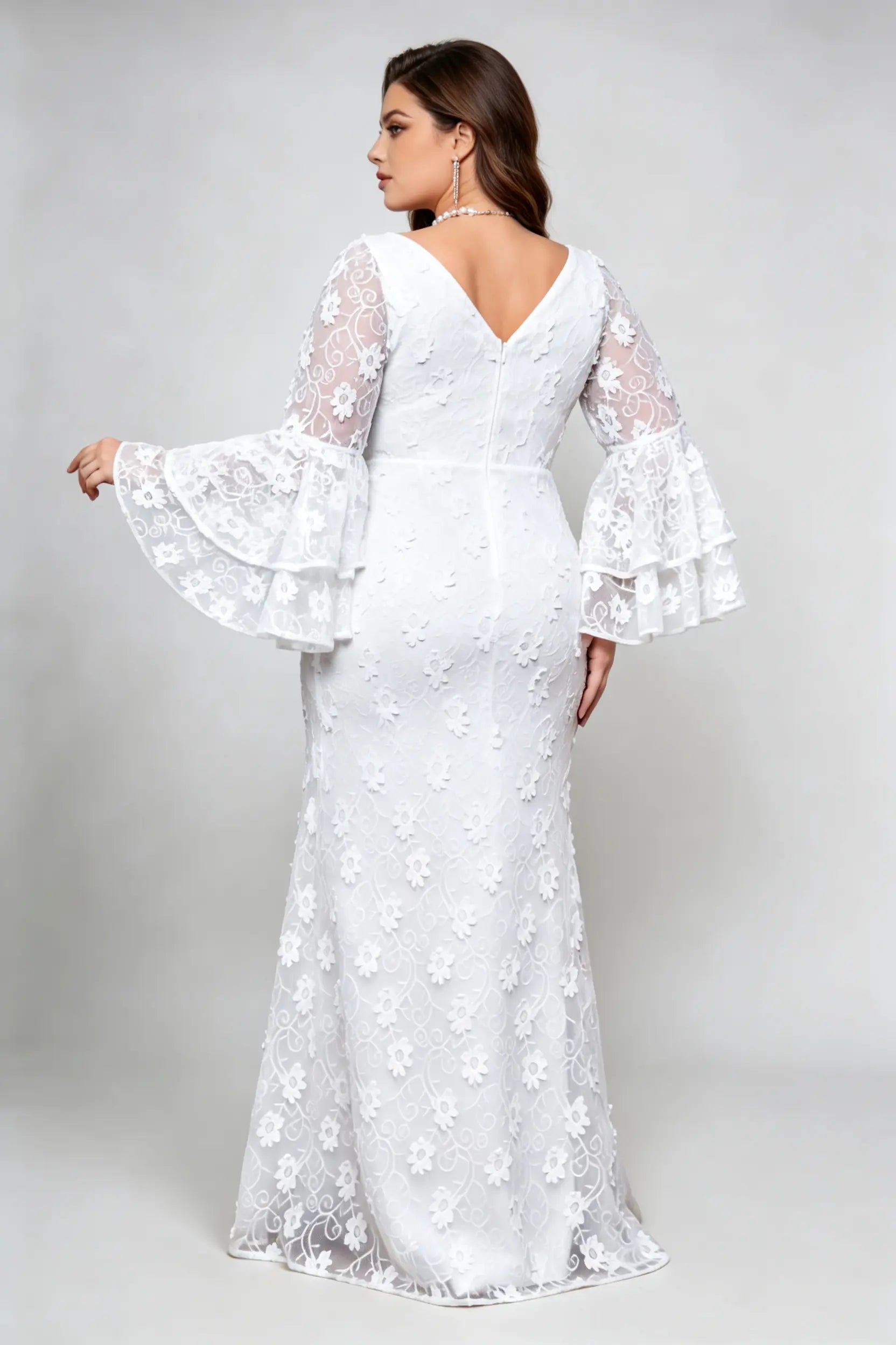 Curvy model wearing plus size v-neck white floral lace maxi dress with tiered bell sleeves