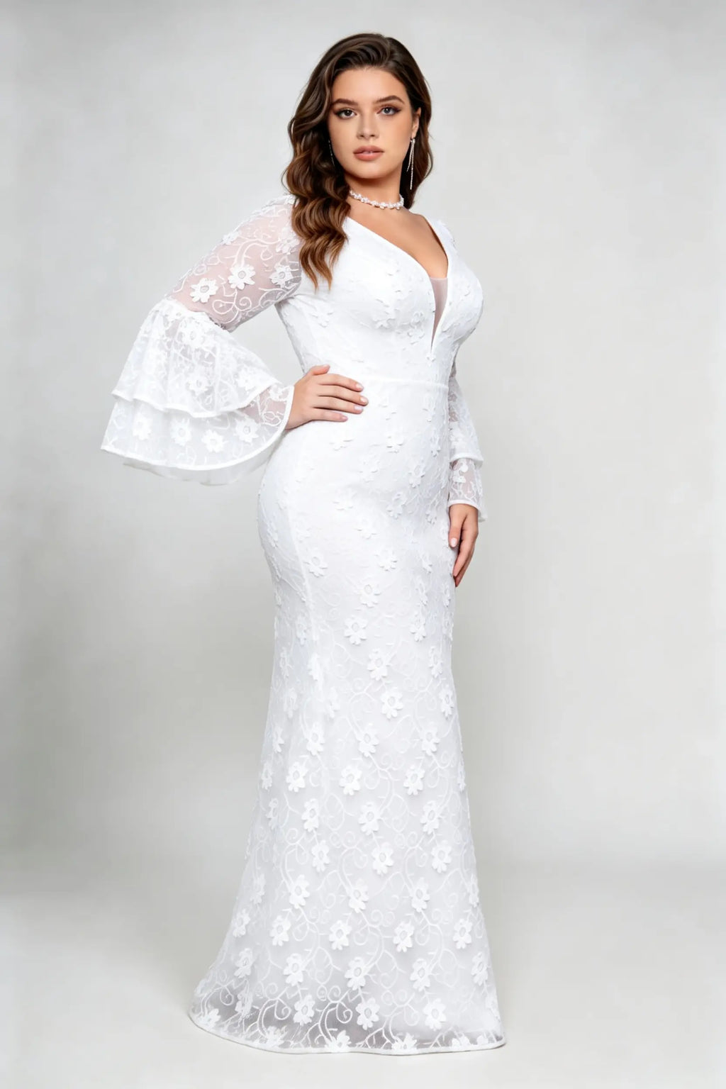 Curvy model wearing plus size v-neck white floral lace maxi dress with tiered bell sleeves